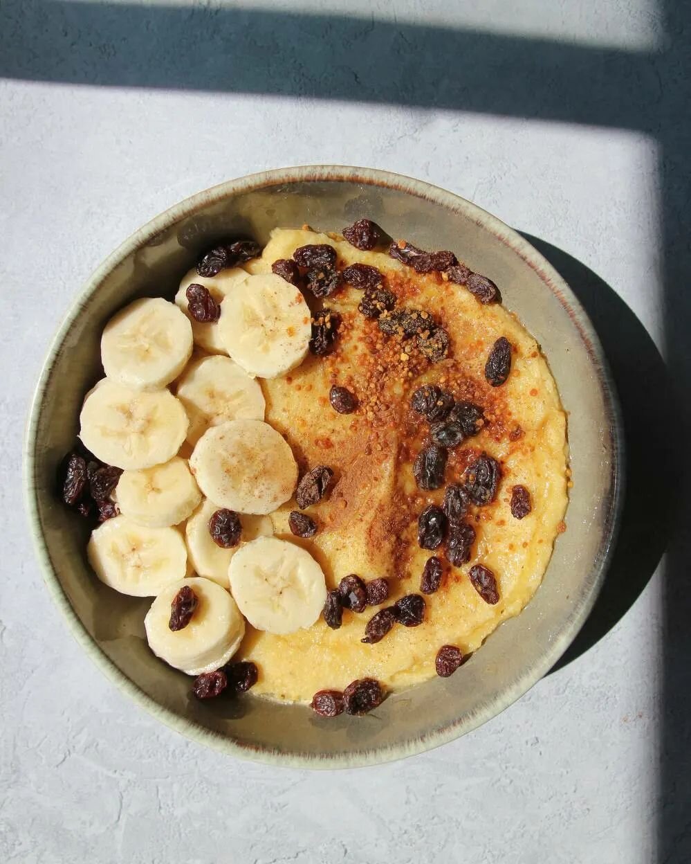 Photos taken seconds before disaster (me desperately trying to convince Alba we have a winning shot so I can mix this bowl up and start inhaling it). Masa Harina, salt, collagen, cinnamon, bee pollen, raw honey, raisins, and bananas. The only thing t