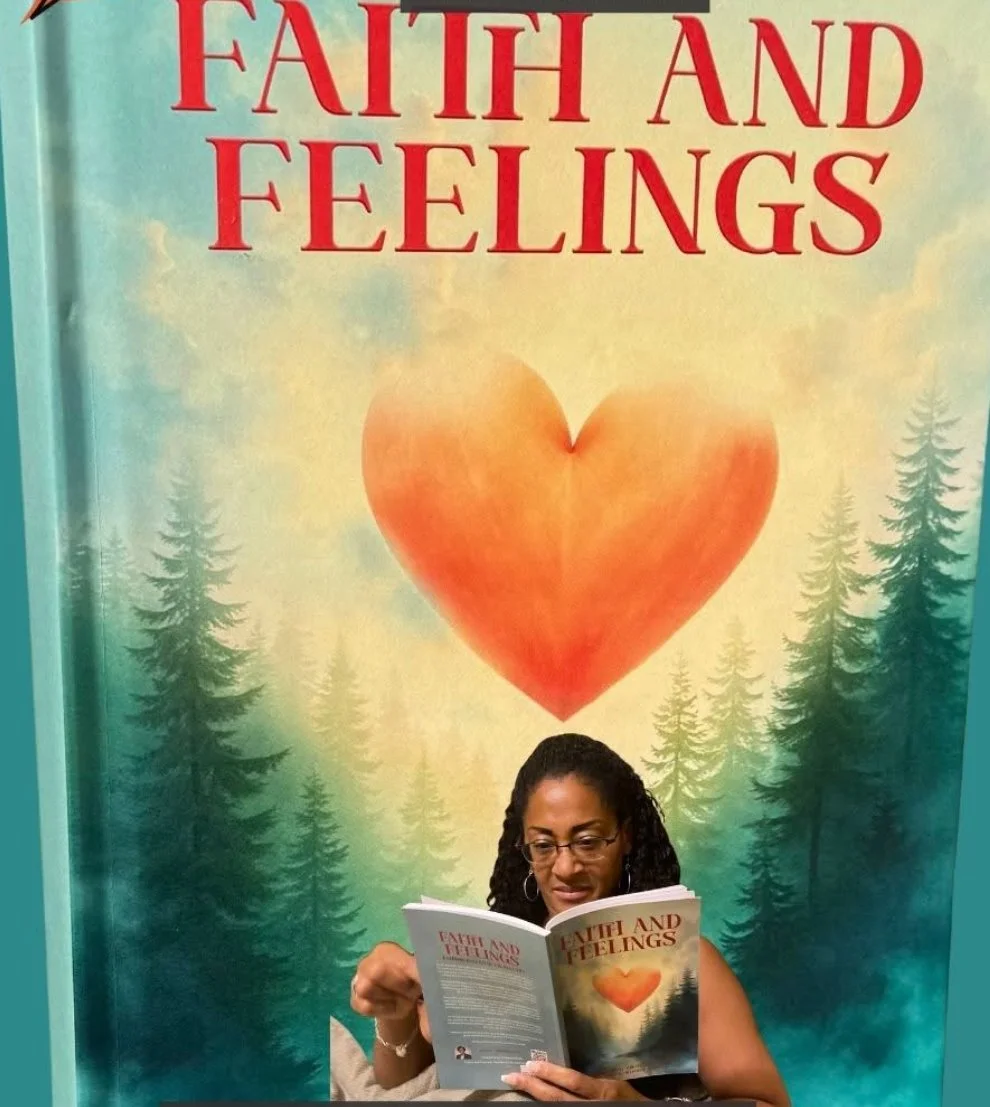 Woman reading a book titled 'Faith and Feelings' in front of a large poster with the same title and a heart-shaped graphic, with a background of pine trees and a sky with clouds.
