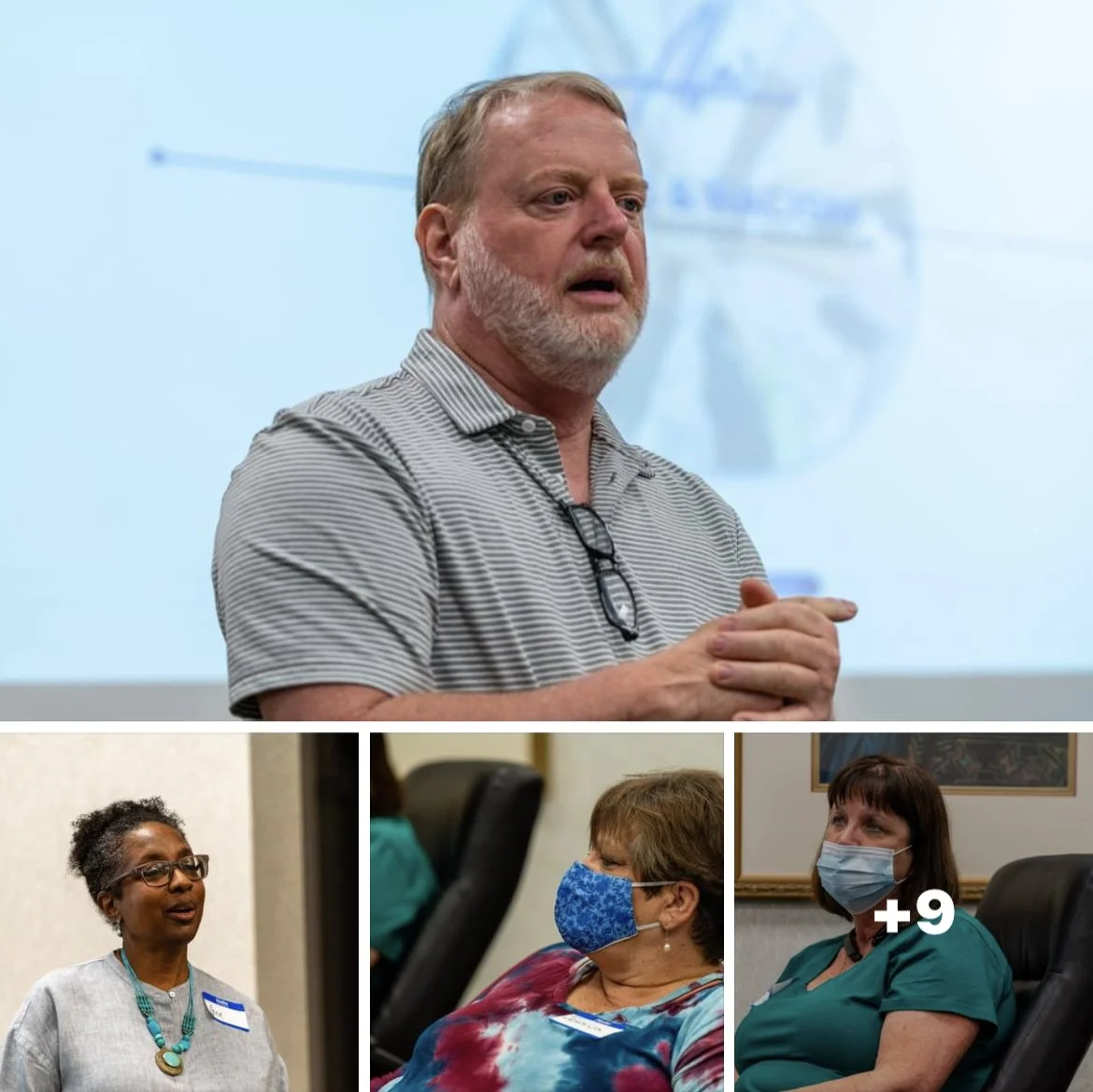 A man giving a presentation with a projected background, and three women with face masks seated and listening at a conference or meeting.