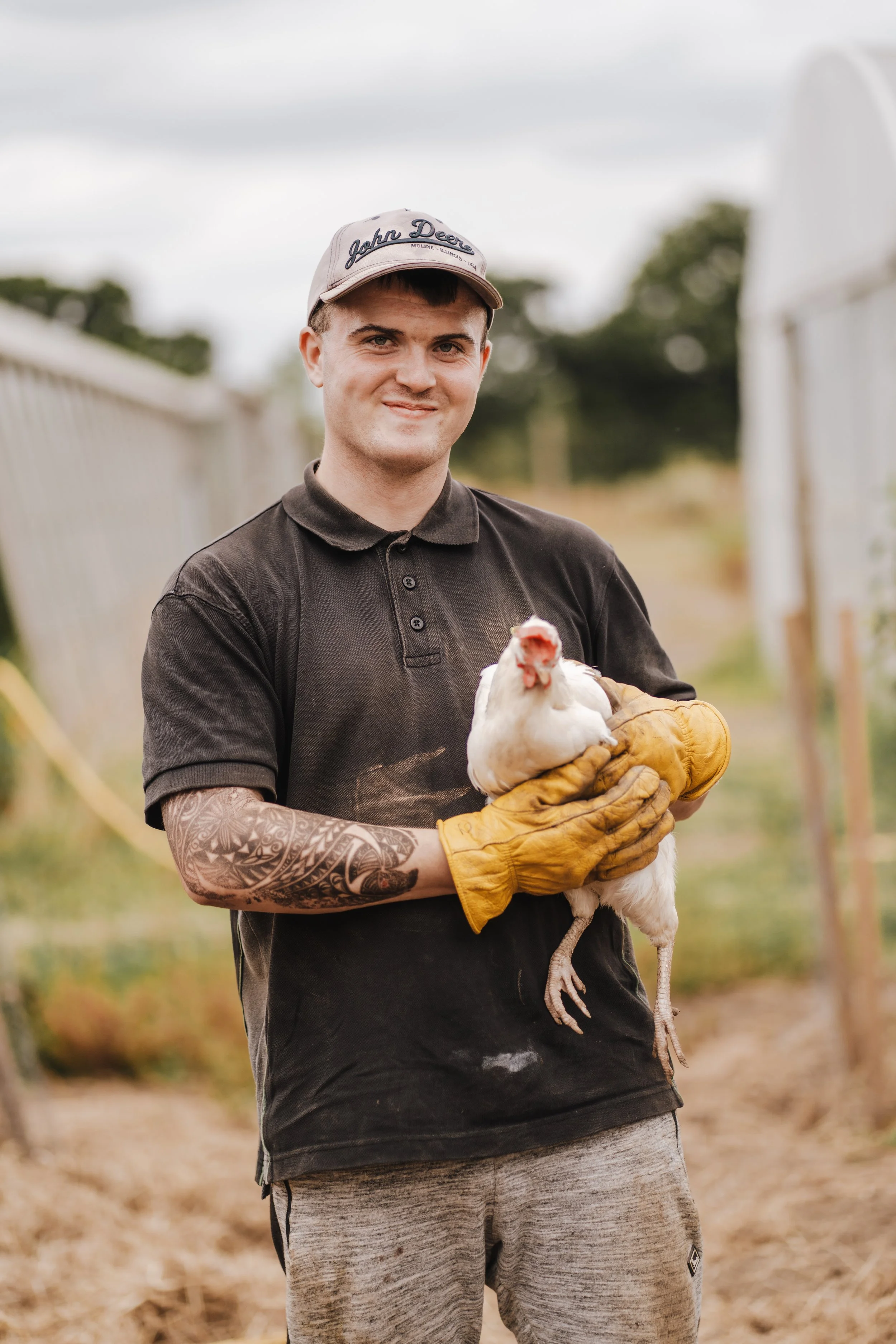 one of our farmers holding a high welfare hen on our farm