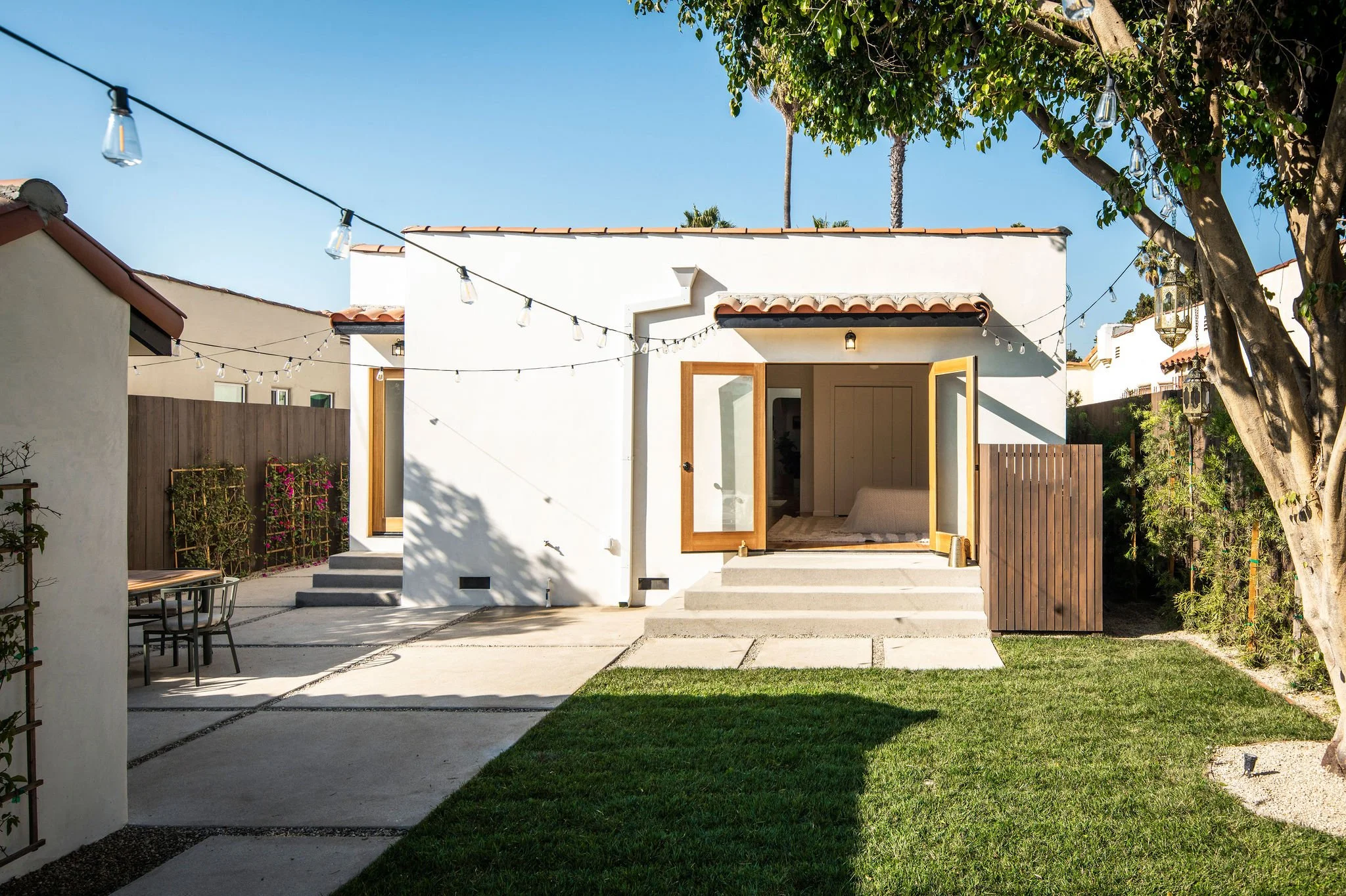 Exterior of a spanish-style house with new modern patio doors.