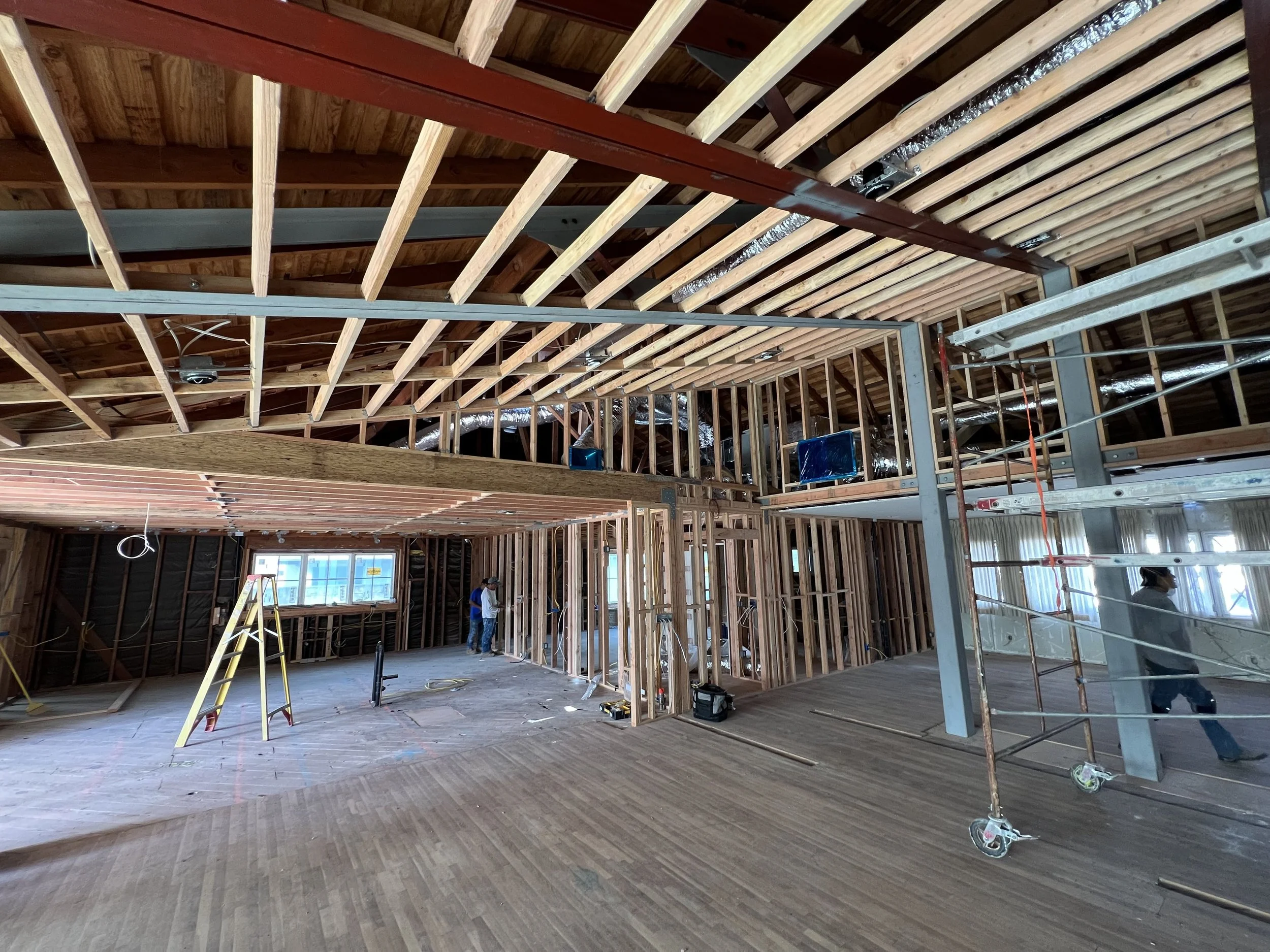 Wide shot showing steel trusses and large wood beams