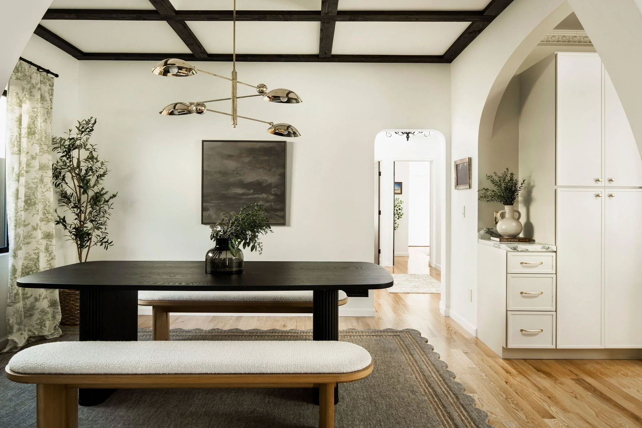 A modern dining room with open flow to the kitchen.
