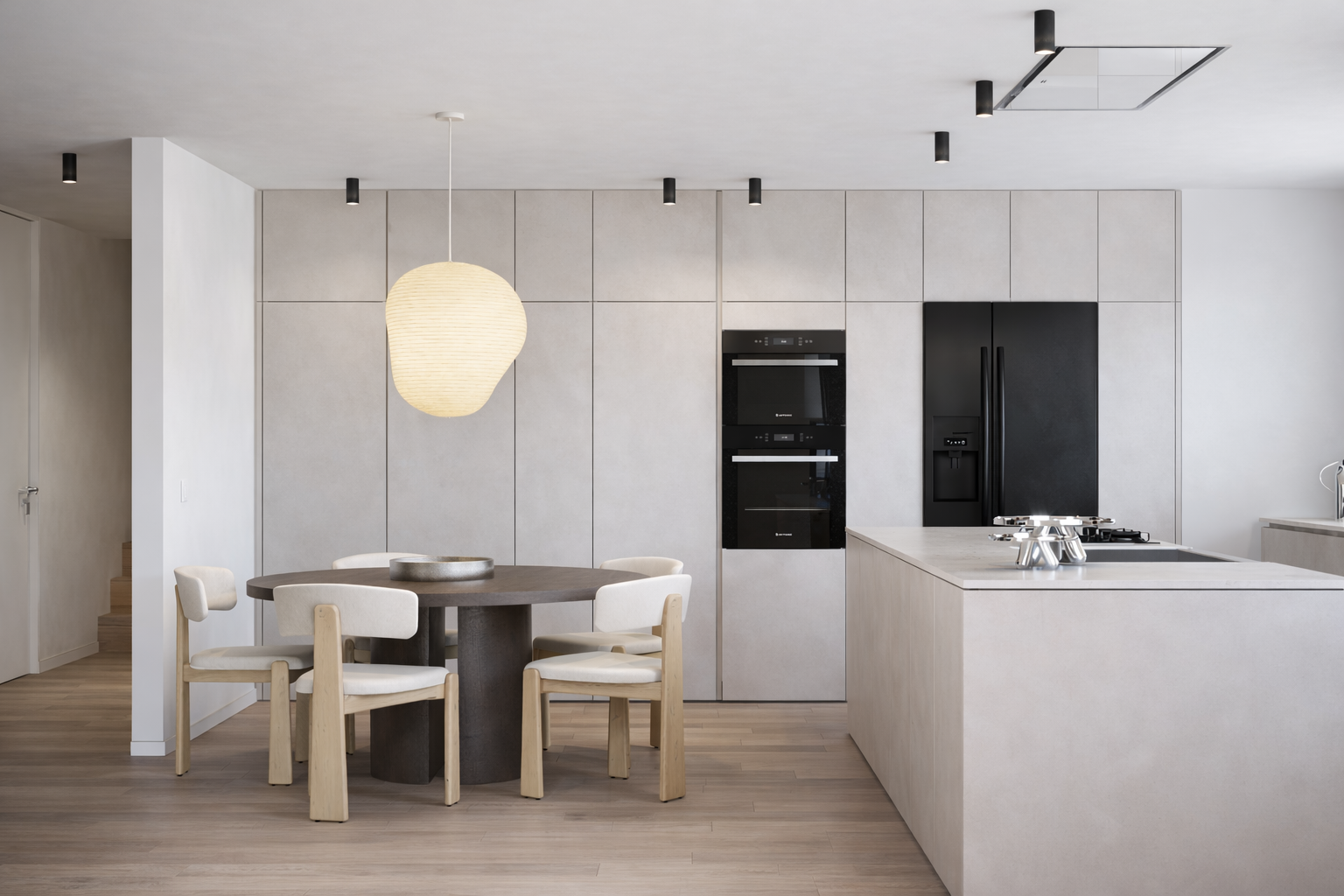 Projeto de cozinha contemporânea com ilha central, materiais naturais e integração entre cozinha e zona de jantar.