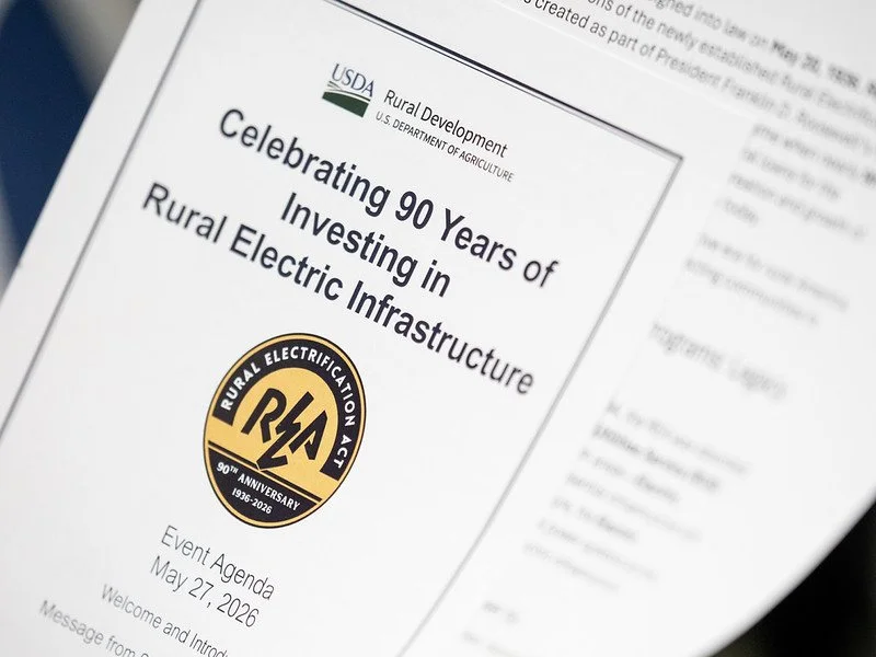 A photo of the program from the 90th anniversary of the Rural Electrification Act. Image courtesy of the USDA.