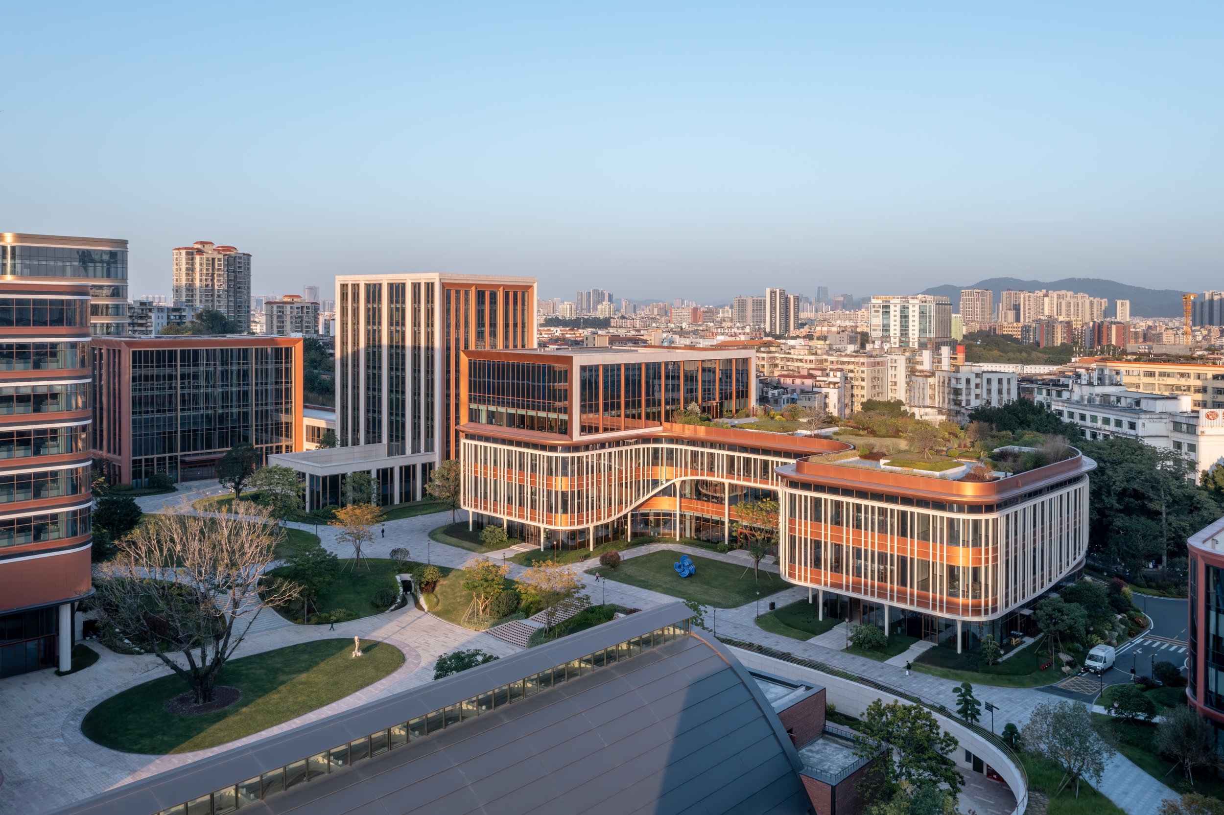 The buildings enclose a landscaped plaza.