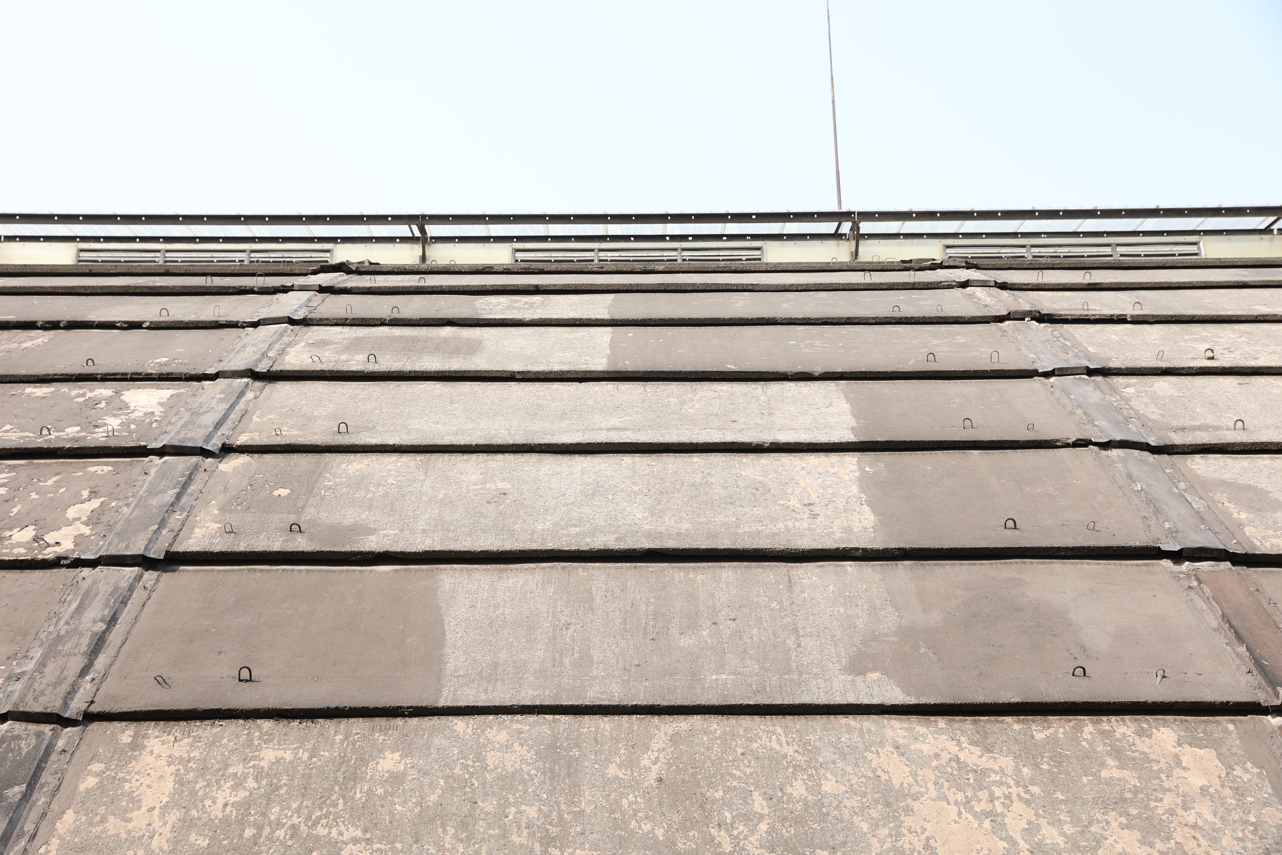 BEFORE RENOVATION - DAMAGED CONCRETE ROOF PANELS