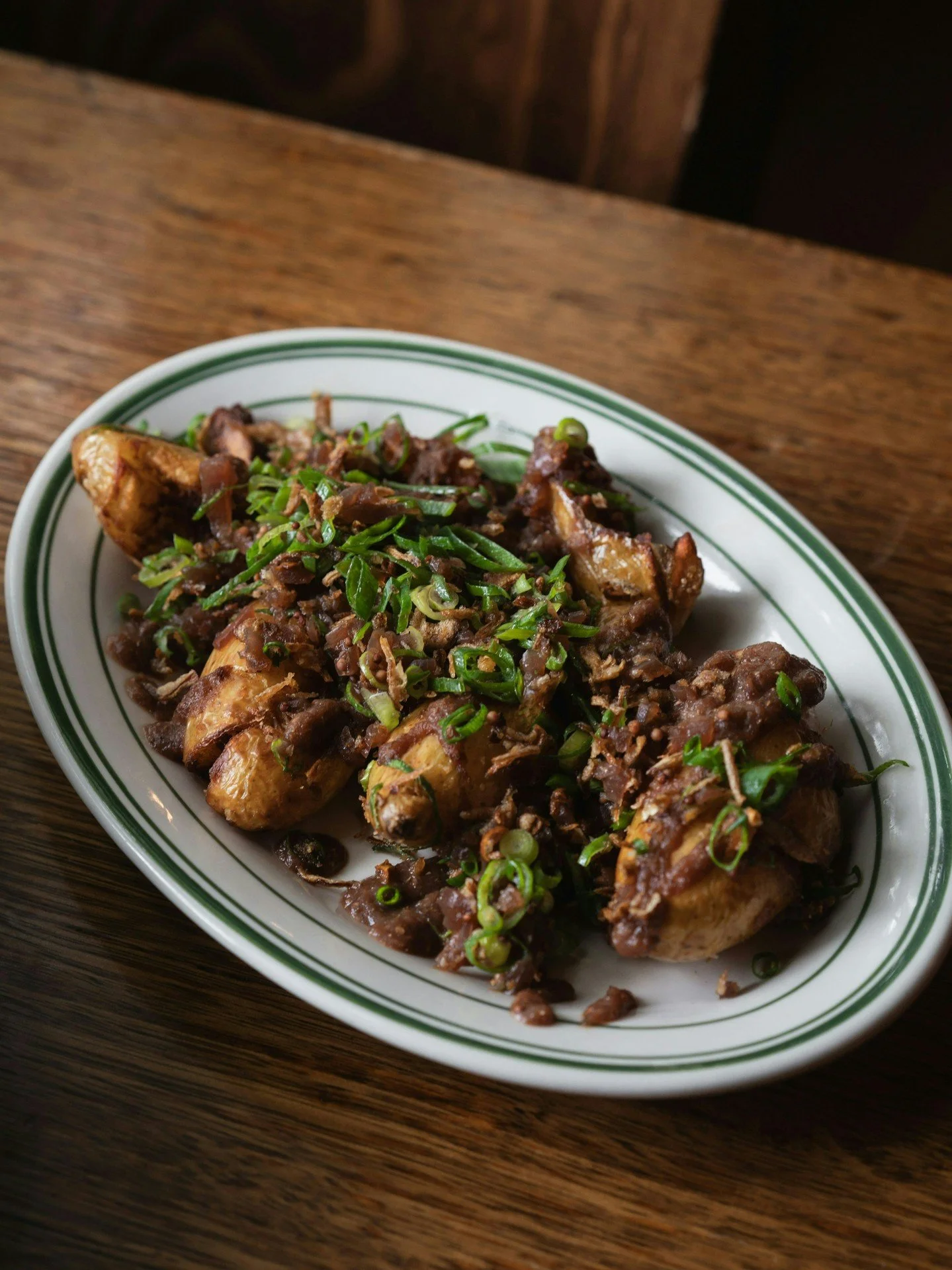 Grandad's Potatoes.
Baby potatoes topped with a stout and wholegrain-mustard jam, with a healthy dose of scallions for good measure.