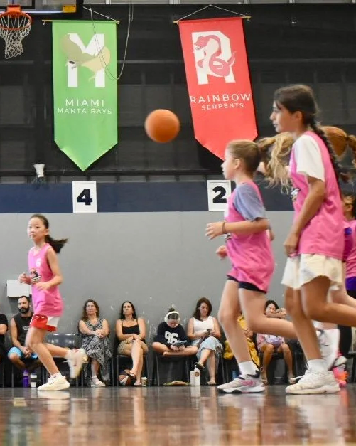 girls in pink jerseys scrimmaging