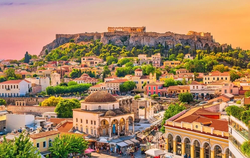 Athens city view with the Acropolis above the Plaka neighborhood at sunset