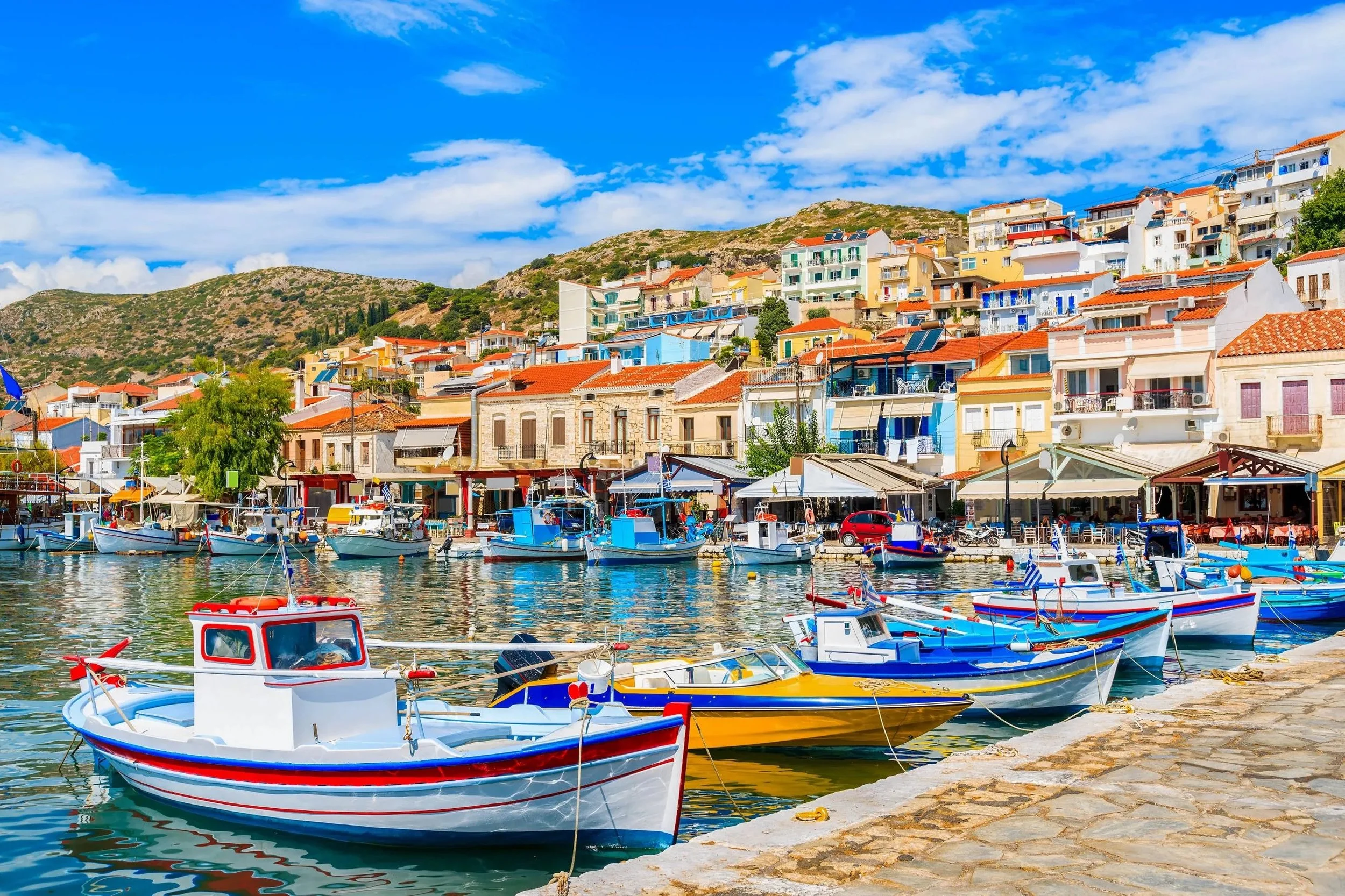 Pythagorion harbor in Samos with fishing boats and colorful waterfront buildings