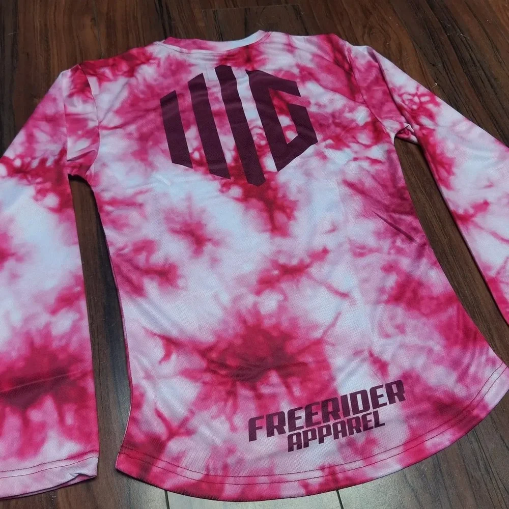 Pink and white tie-dye long-sleeve shirt with dark logo and text reading "WD" and "Freerider Apparel" on the back.