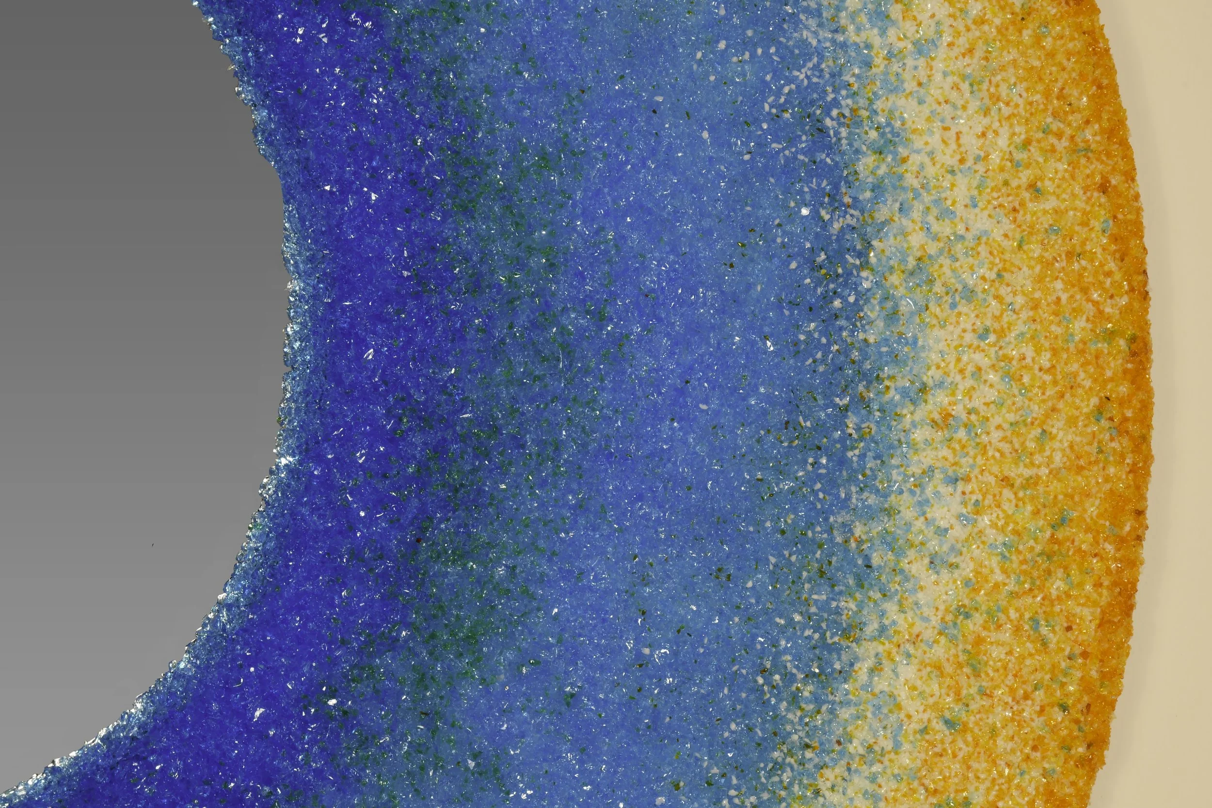 One-of-a-kind circular mirror handcrafted in Rome using MicroCristallo Fusione™ with Murano glass crystals in luminous Mediterranean blues and gold.