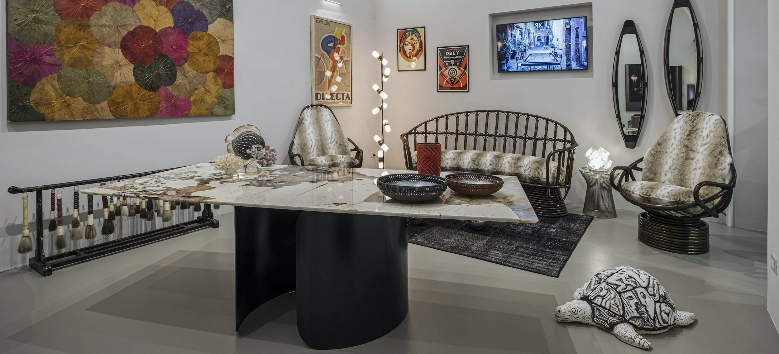 Curated mid-century furniture, sculptural table, and design objects displayed in KalaRara Roma gallery setting