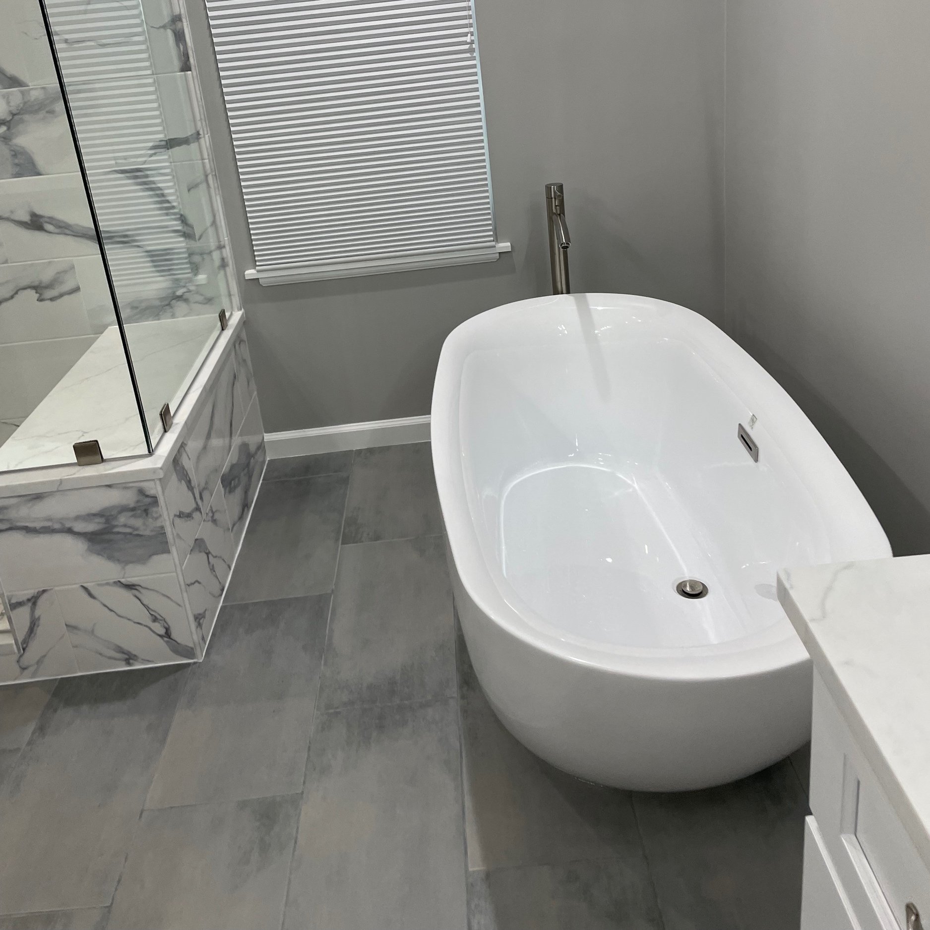60" Wyndham Collection soaking tub with versatile mid grey matte porcelain floor tile