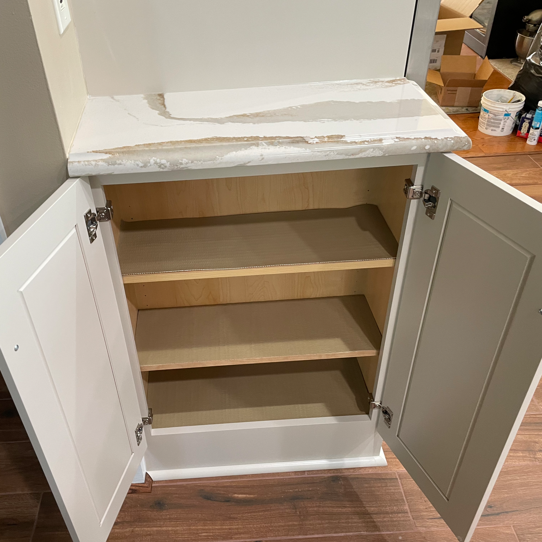 Built out wall for sub-zero refrigerator and efficiently used remaining space for small cabinet and counter.