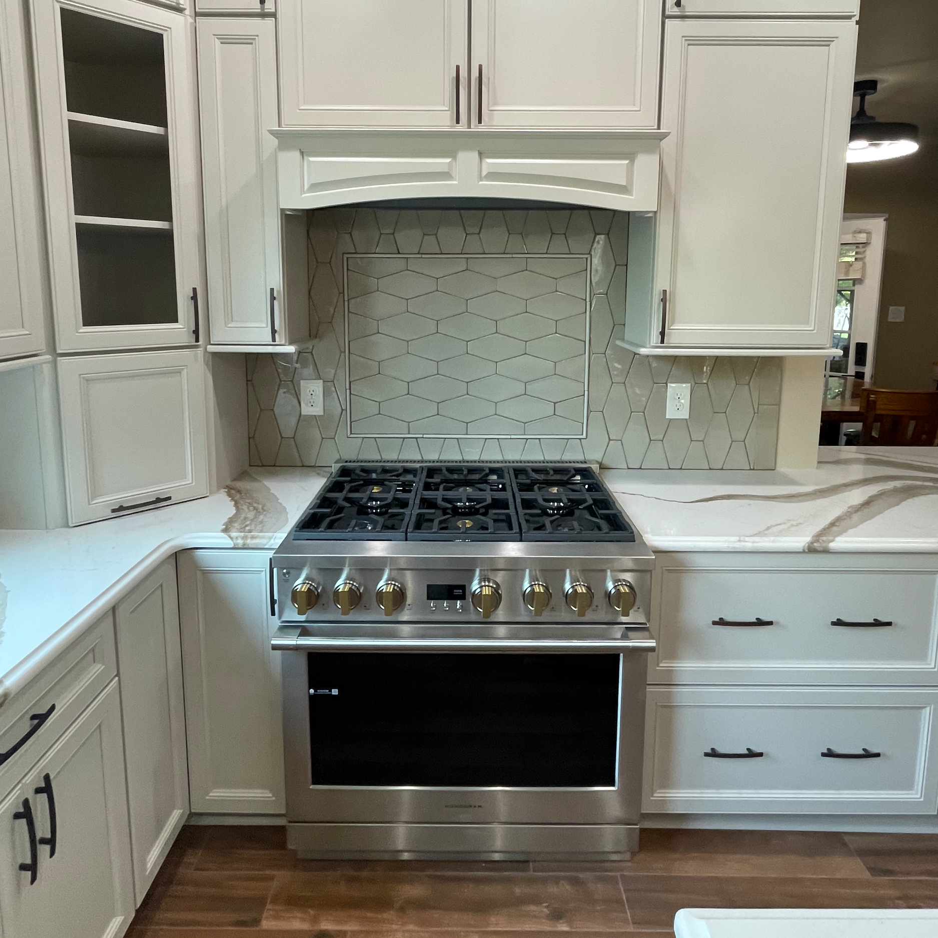 Monogram dual fuel oven. Backspash and framed in set from Best Tile.