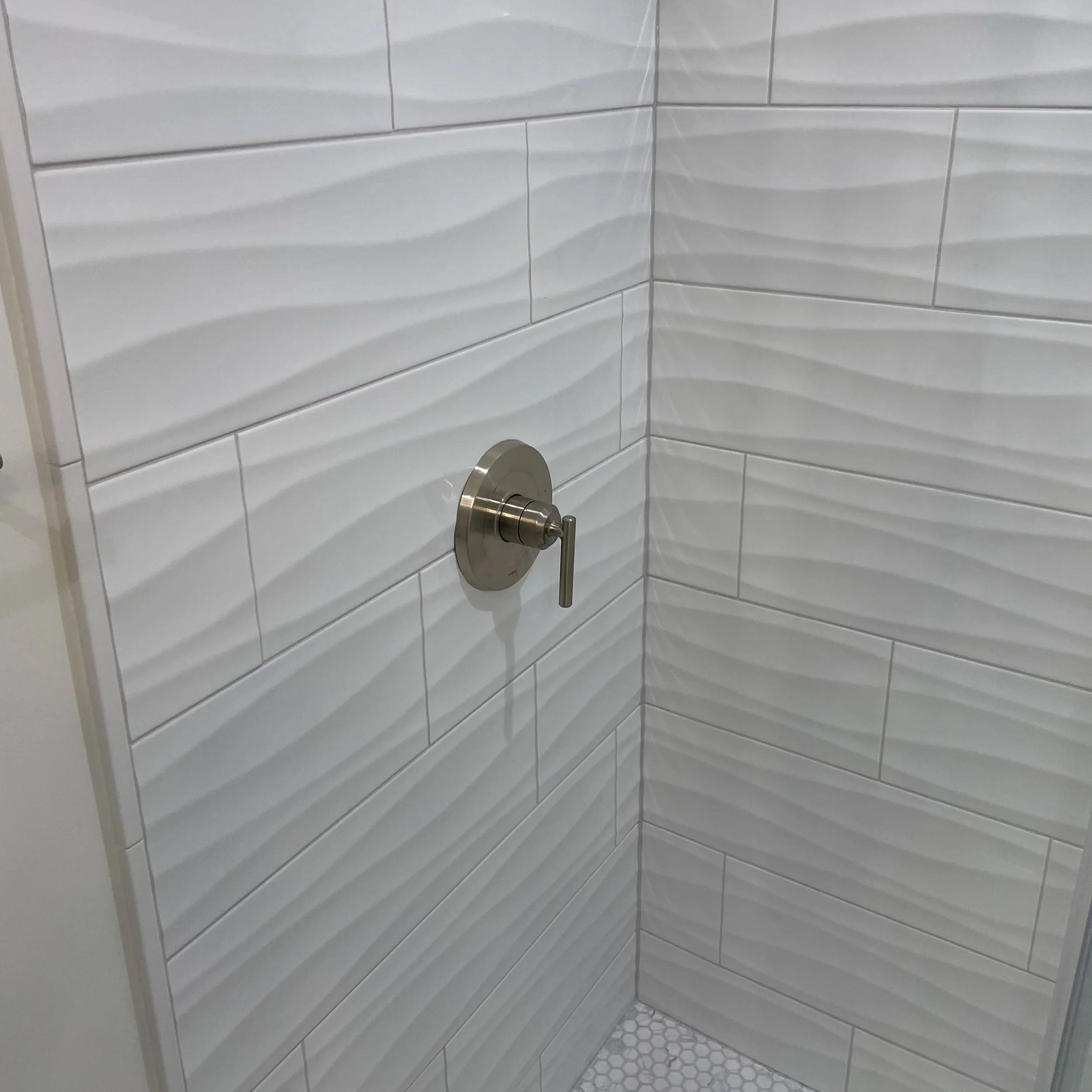 Shower valve moved to left side for easier access