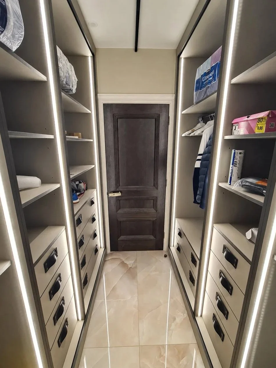 A luxury walk-in closet featuring bespoke storage, integrated LED lighting, custom shelving and tailored drawer organisation.