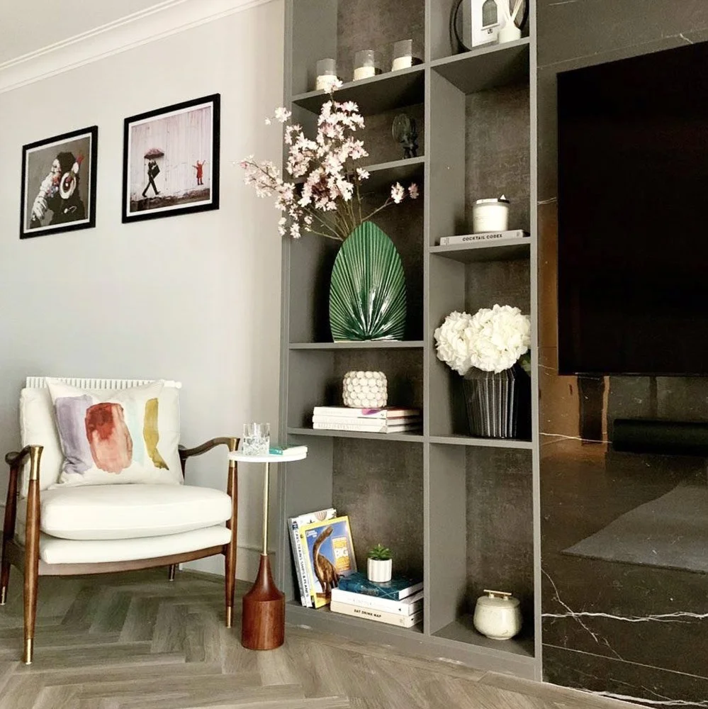 Made-to-measure display shelving in black wenge finish with decorative lighting, fitted cabinetry and contemporary living room styling.