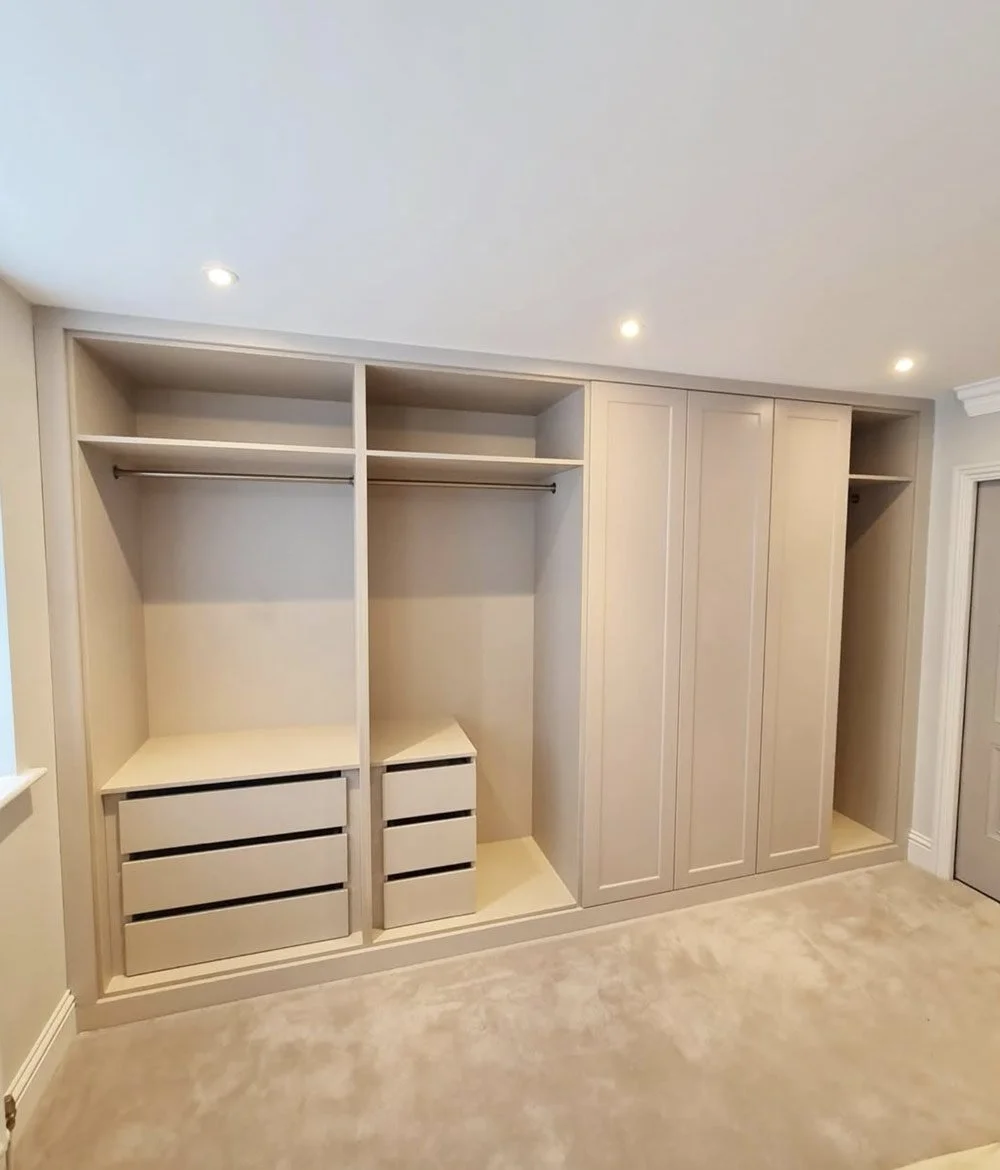 A made-to-measure fitted wardrobe installation with tailored hanging space, drawer storage and custom internal organisation.