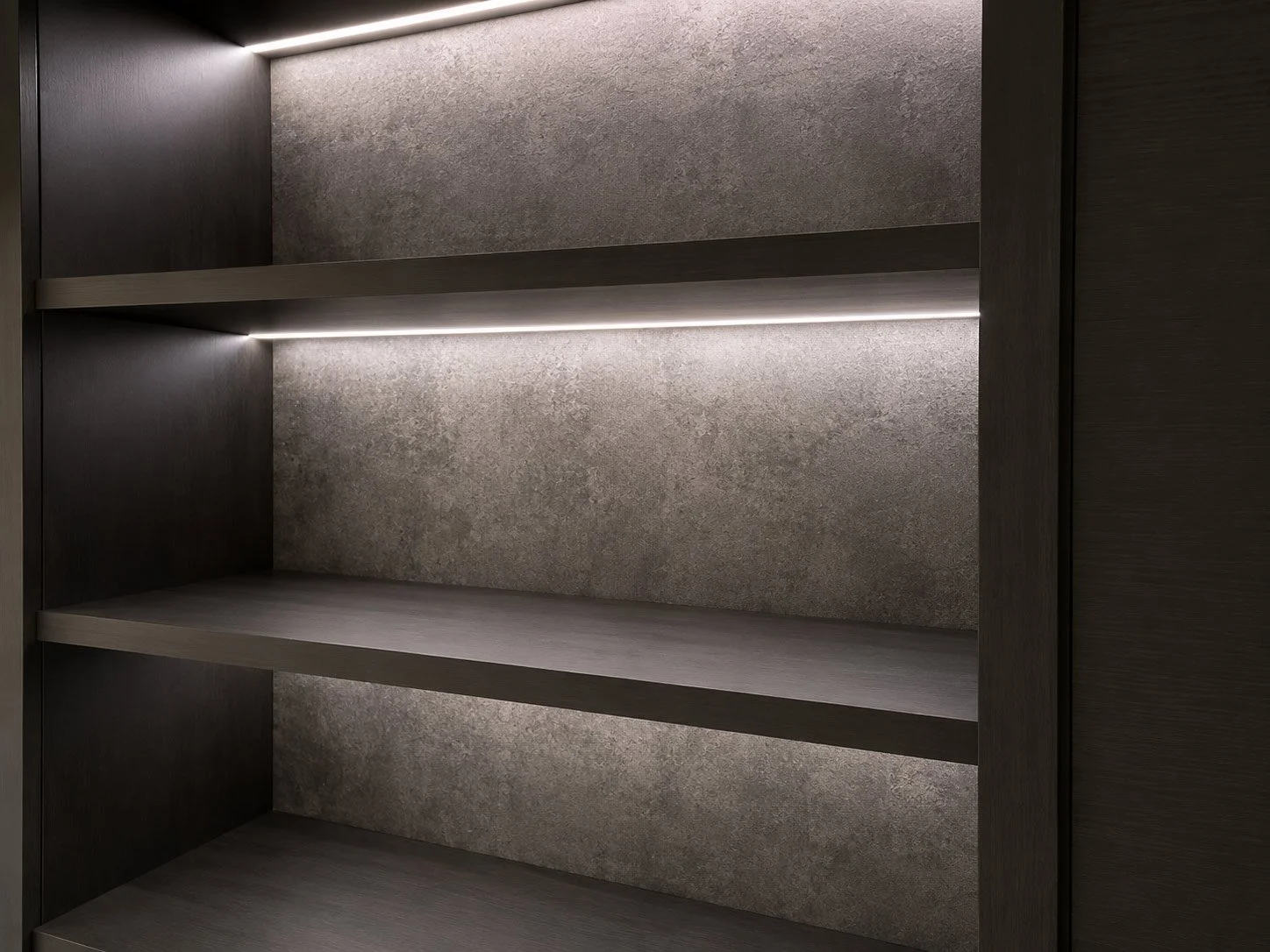 Close-up of illuminated display shelving showcasing the craftsmanship, materials and integrated lighting of a bespoke media unit.