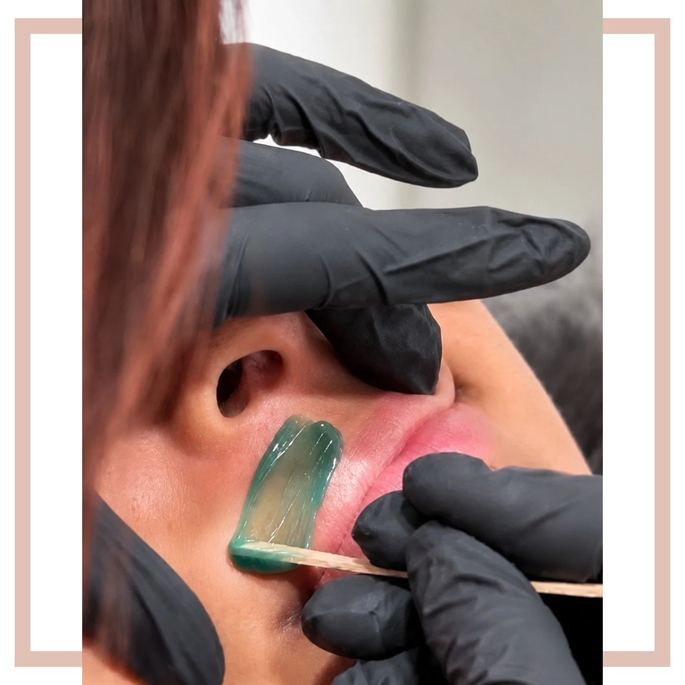 Licensed esthetician preparing hard wax for a facial waxing service near me.