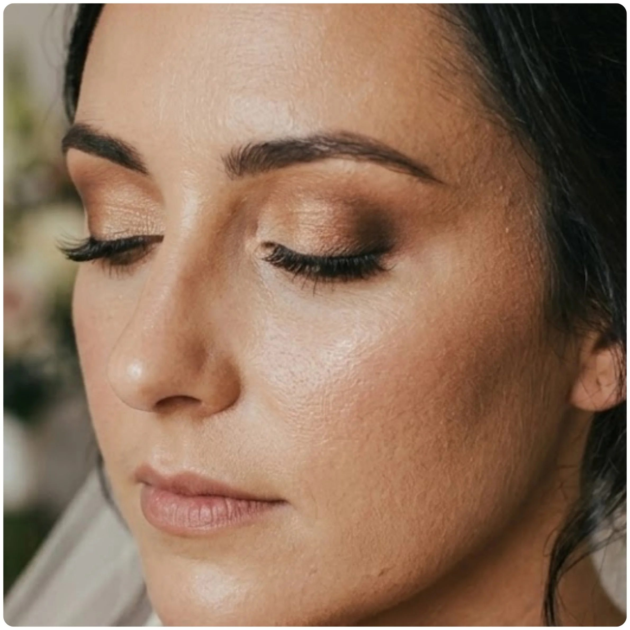 Soft glam bridal makeup featuring warm taupe eyeshadow, expertly blended individual lash extensions, and a flawless natural foundation base.