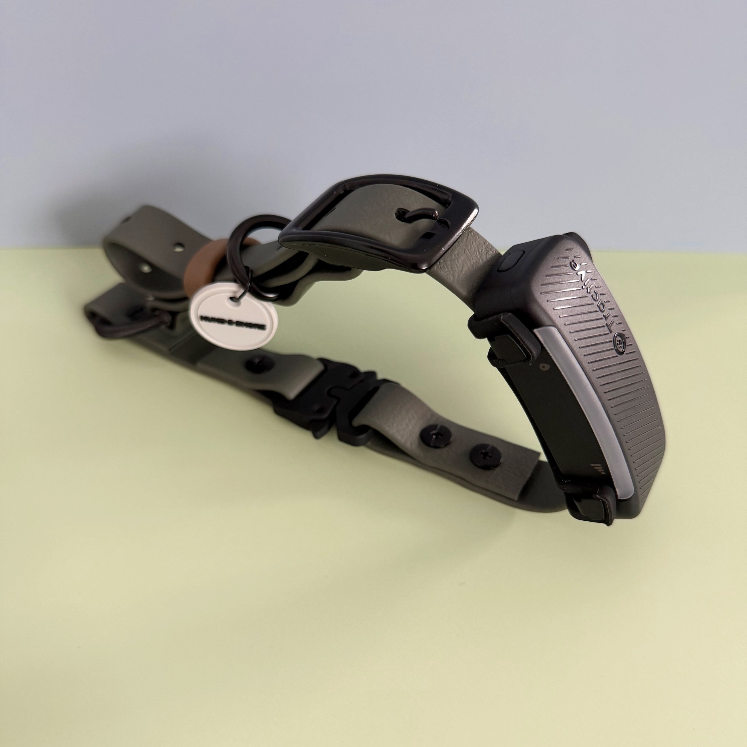 3/4 inch olive biothane e-collar strap with black quick-release buckle and Garmin tracker mounted