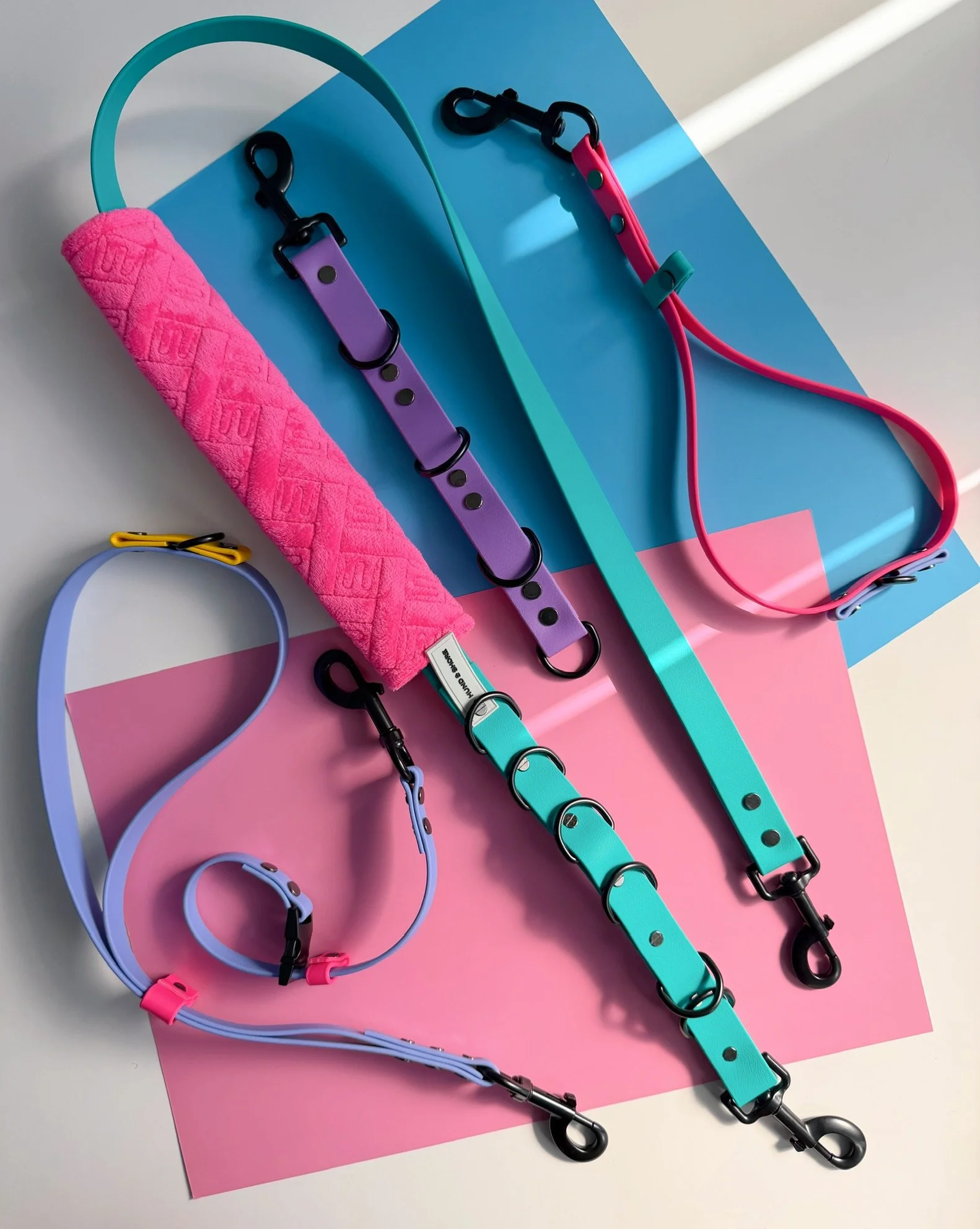 Hund and Shore 90s themed professional dog grooming bundle including belly band with comfort pad grooming loops and extender straps in teal purple pink and yellow biothane
