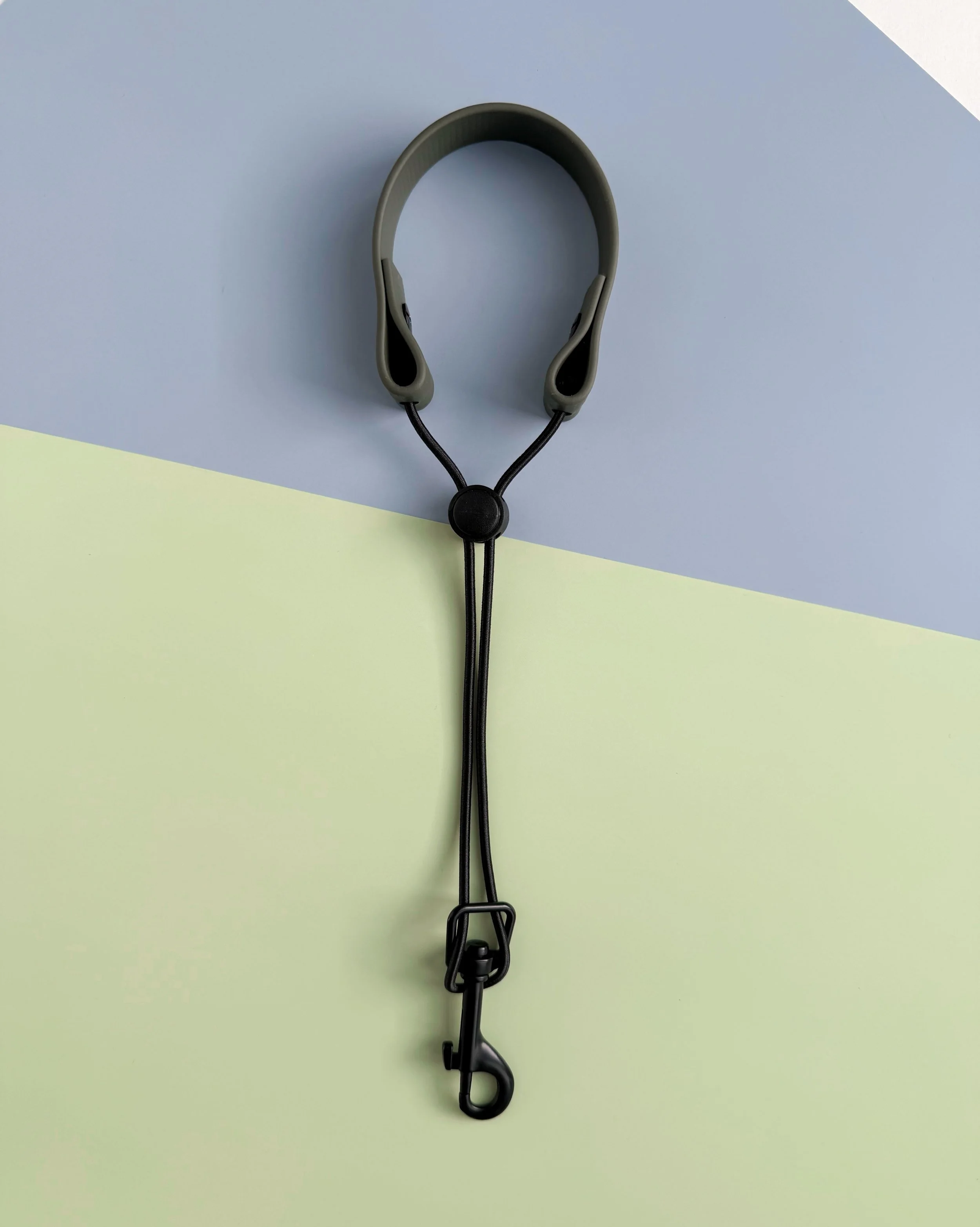 Premium biothane remote wrist lanyard in olive with adjustable cord lock and black bungee attachment