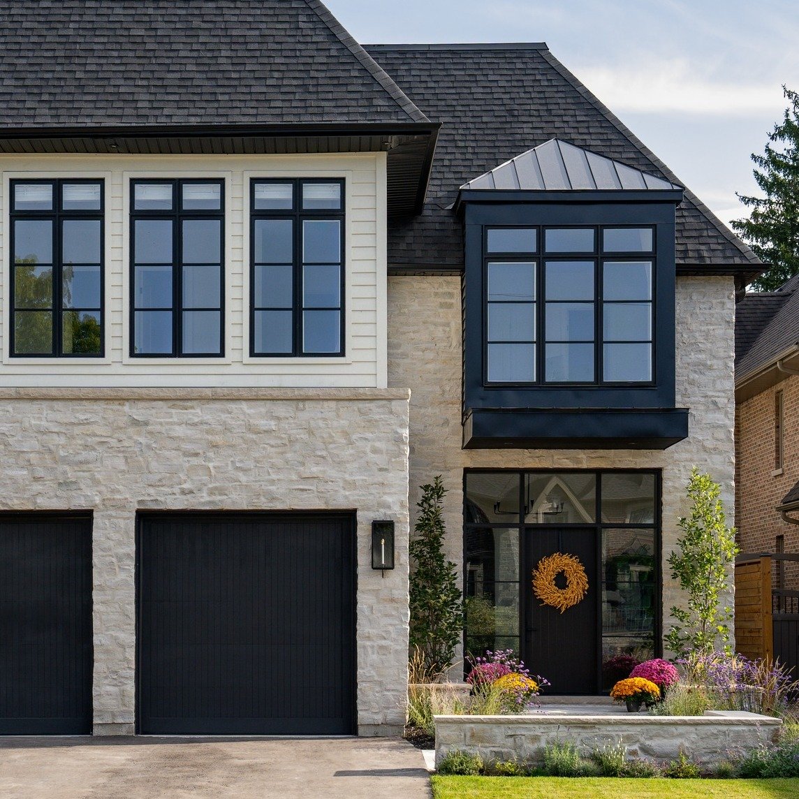 One of our custom homes, captured beautifully by @danmolinastudio 

Light stone and soft cream @jameshardie  boards give the exterior a warm, timeless feel, while black windows add contrast and depth. The steel roof grounds it all &mdash; clean, dura
