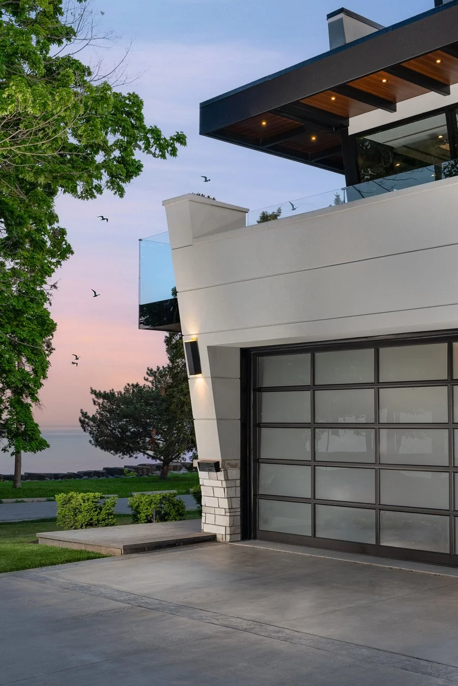 close-up of the garage door and upper patio at sunset of the Meadow Wood residential architectural project in Mississauga, Ontario