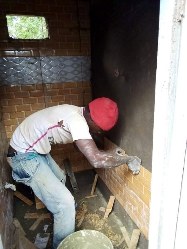 Worker installing tile