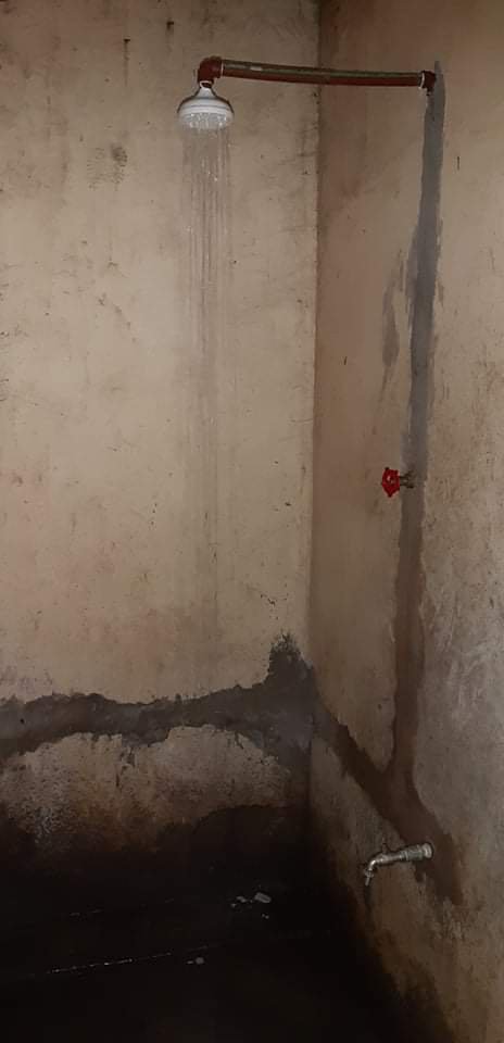 New shower stall with running water before tiling