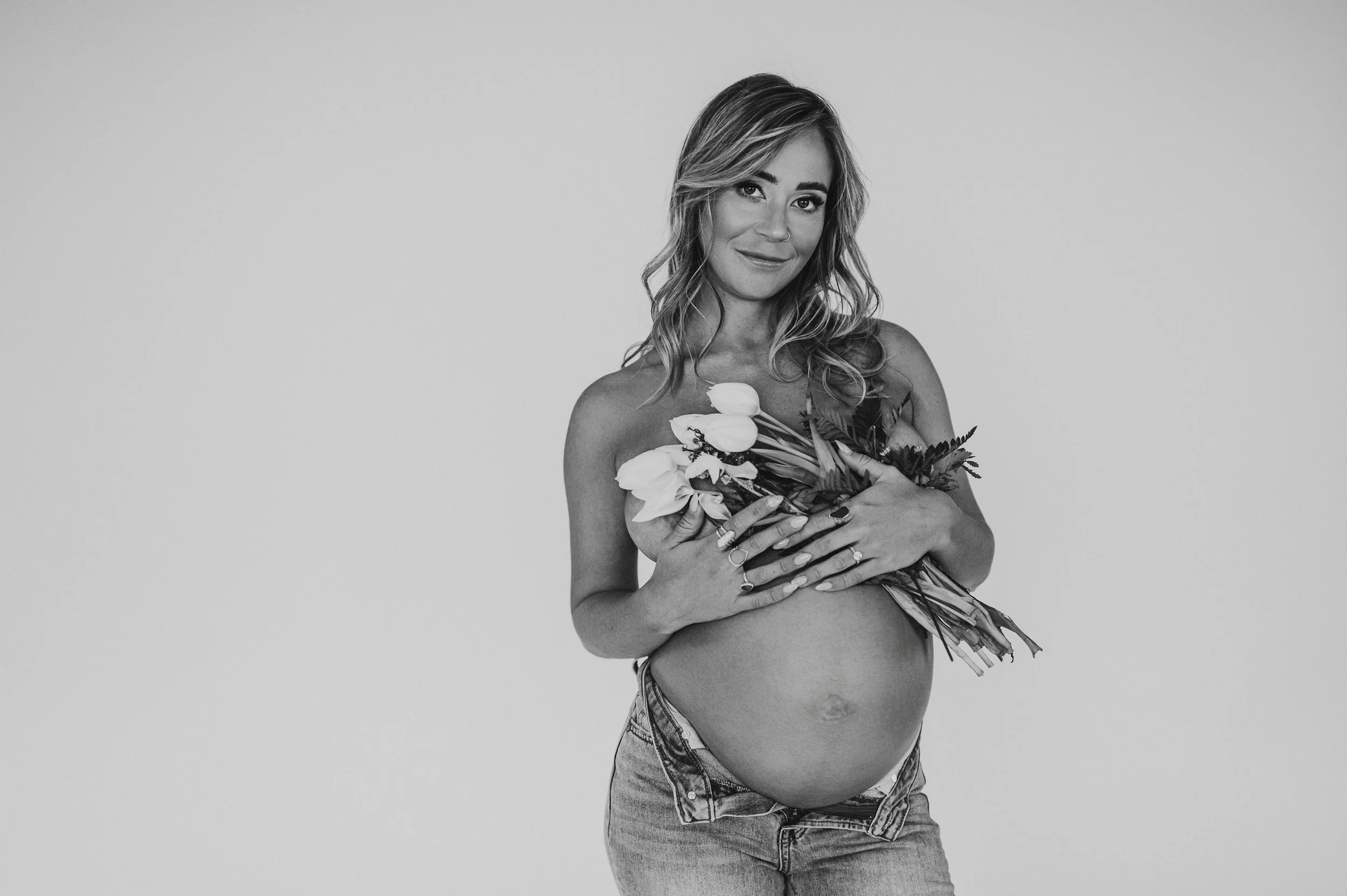 Blonde woman holds flowers over her chest in Dover photo shoot