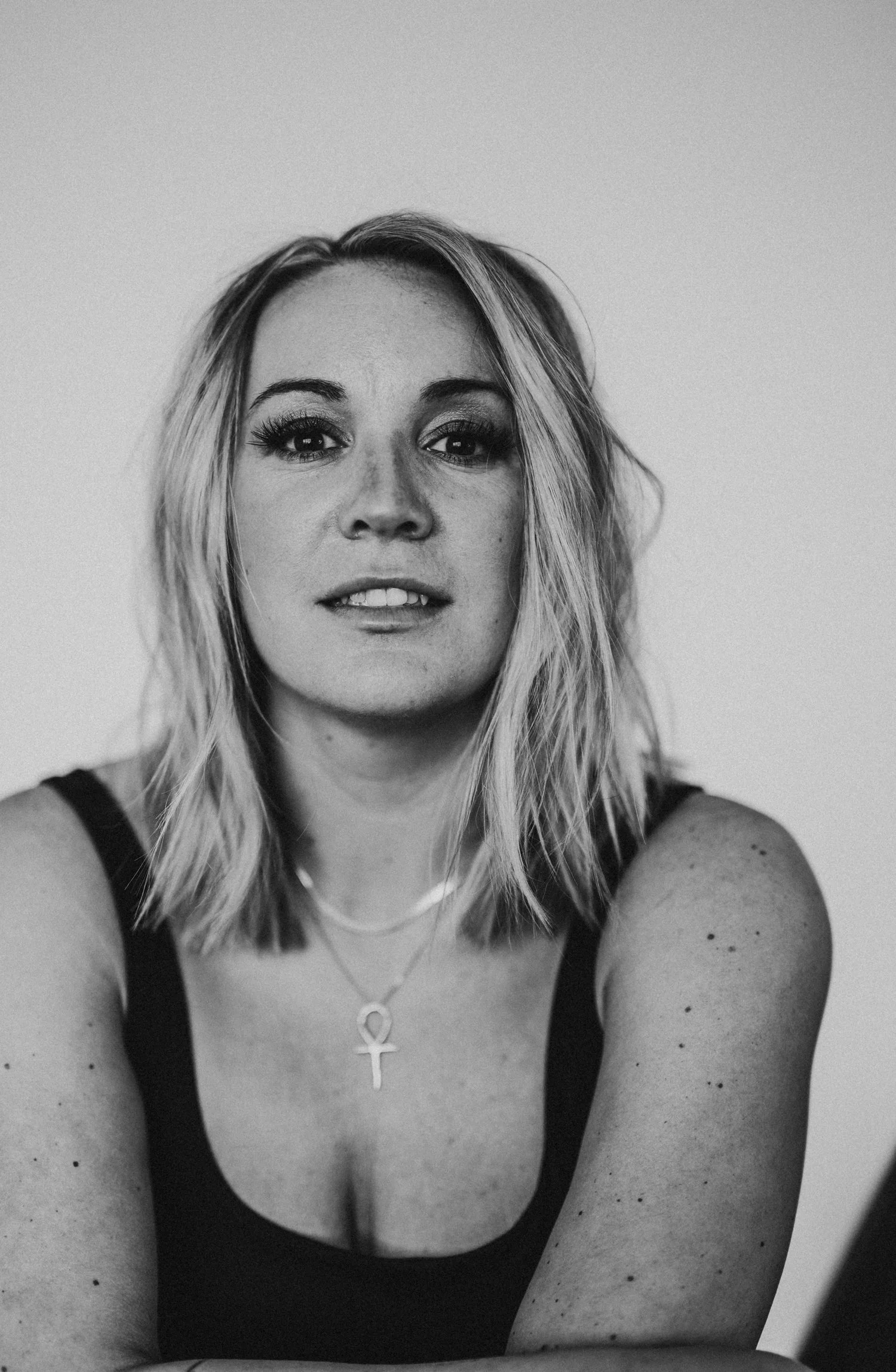 blonde woman in tank with necklaces for empowerment session