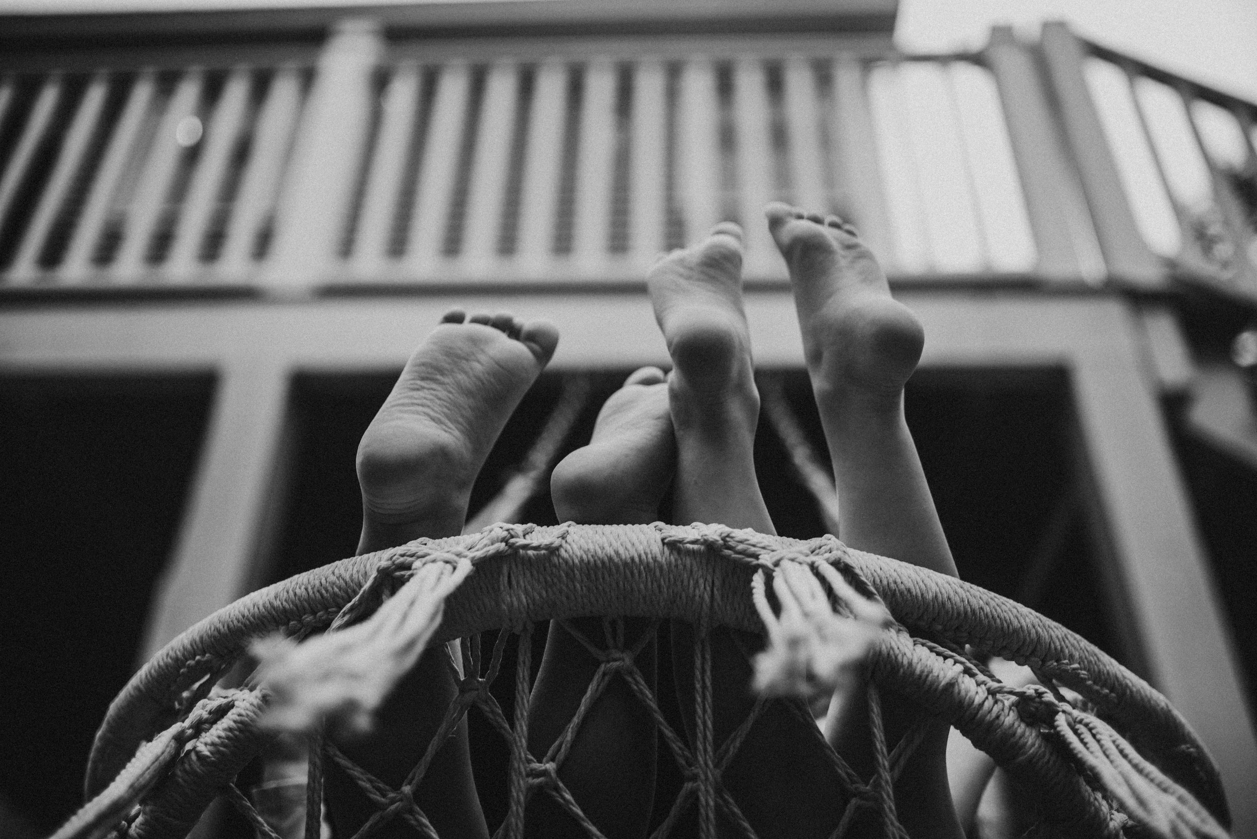 tiny feet peeking over a disc swing by New Hampshire boudoir photographer