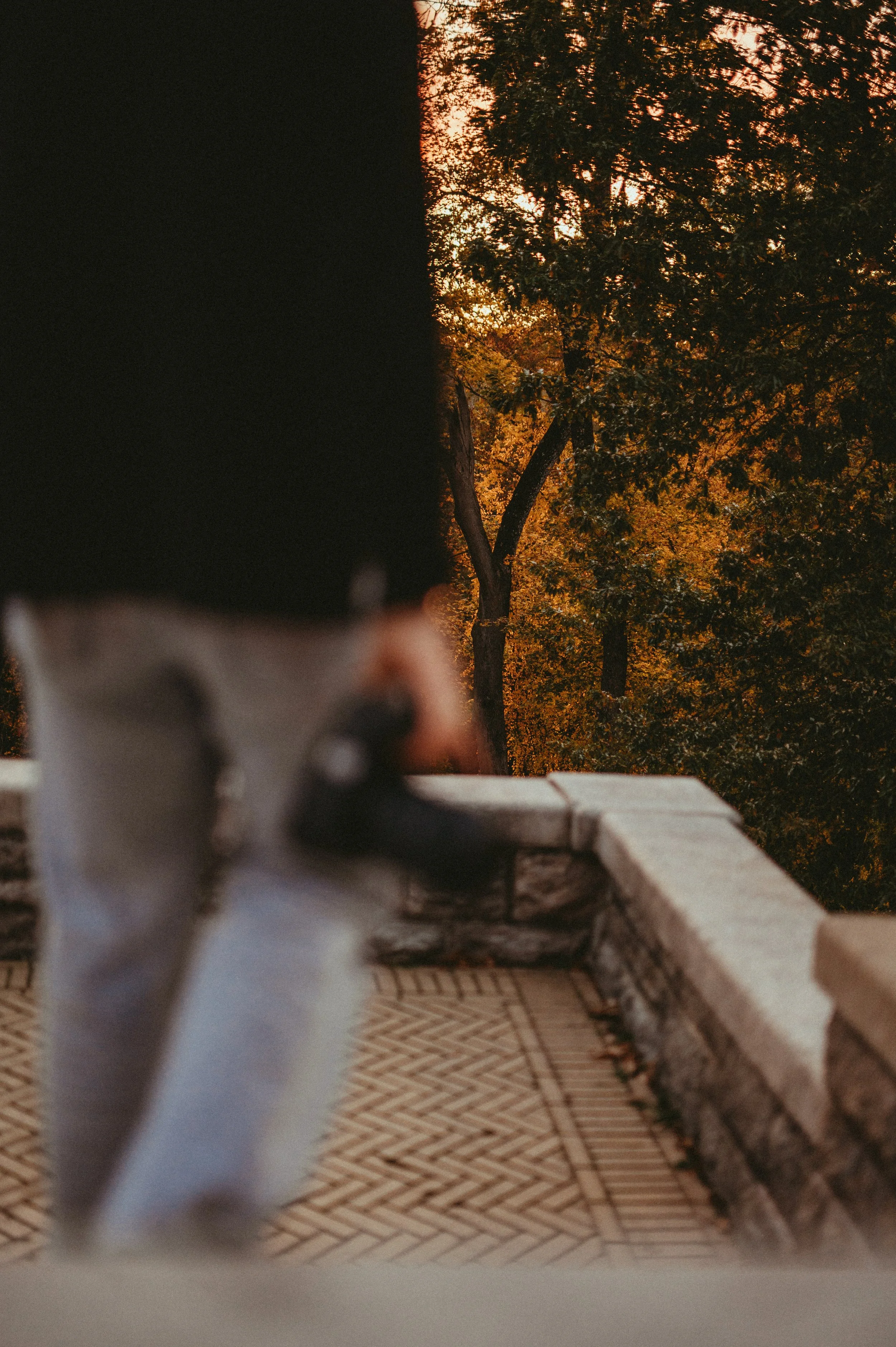 woman with camera walks out onto patio by New Hampshire boudoir photographer