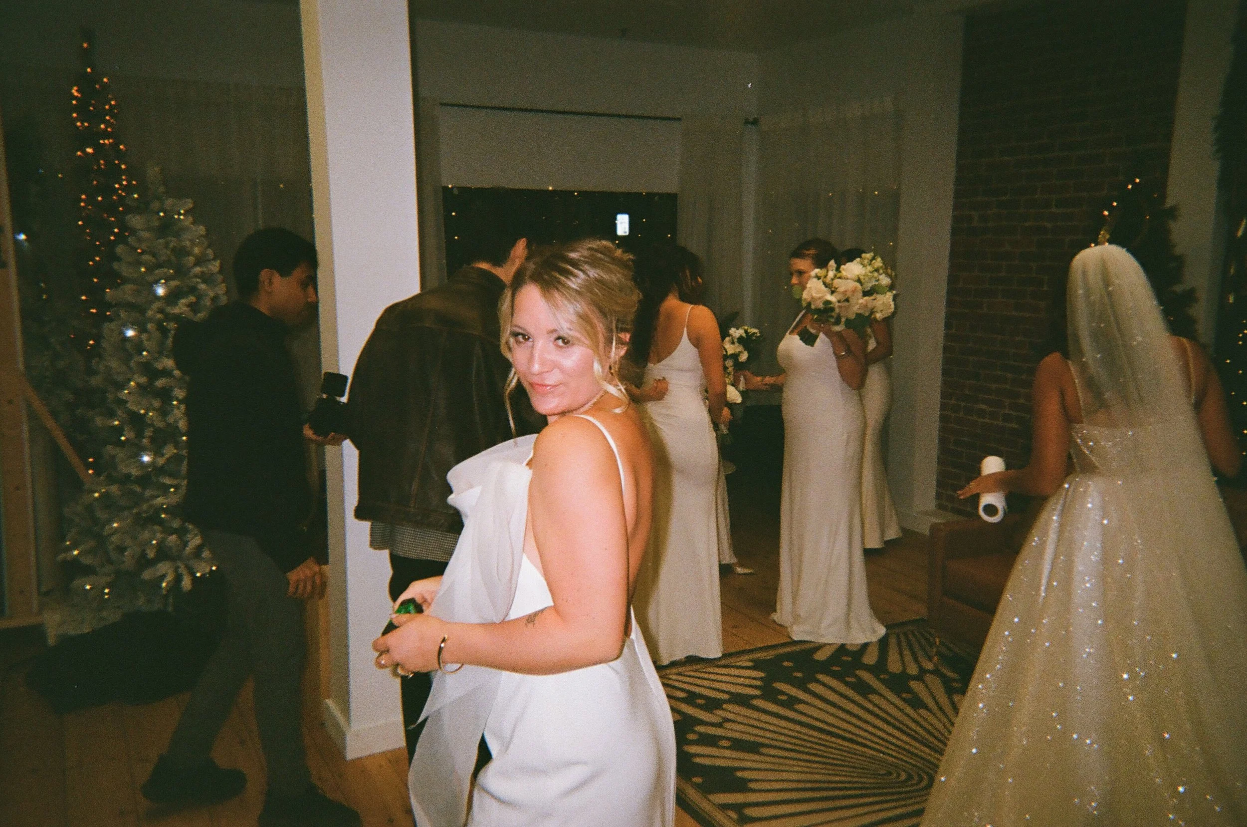 bride looks over her shoulder at reception by New Hampshire boudoir photographer
