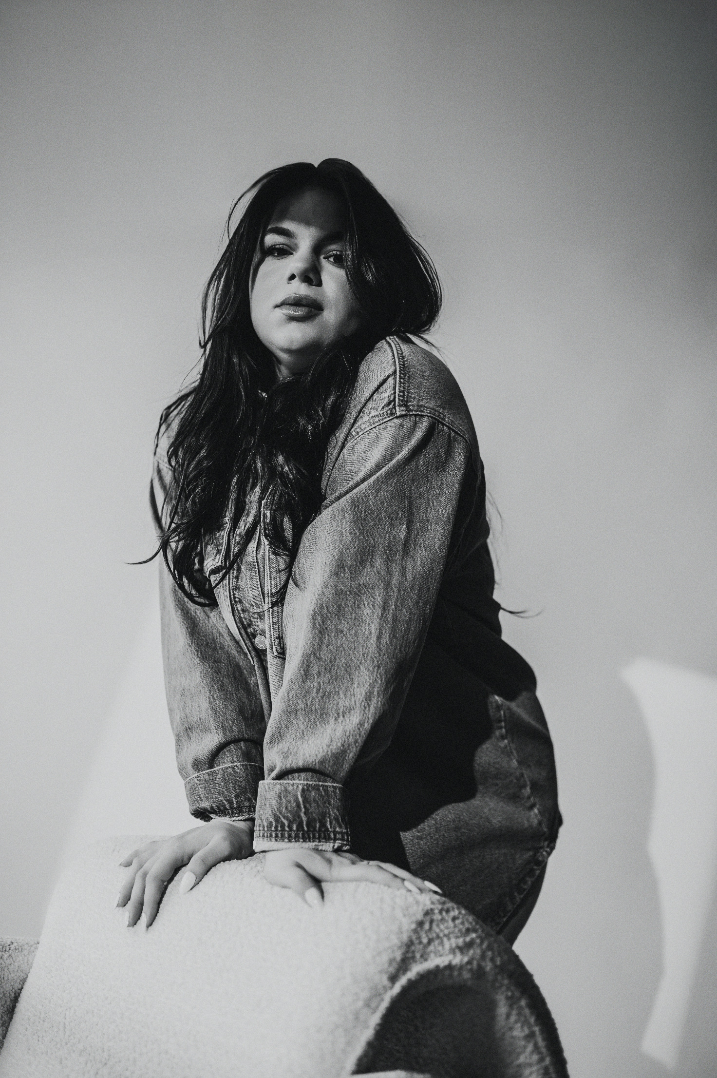makeup artist leans over chair in Dover Studio
