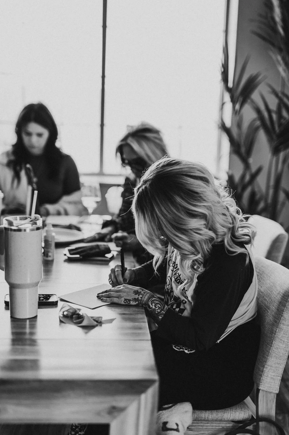 group of people at table writing by Hannah Mac Studios