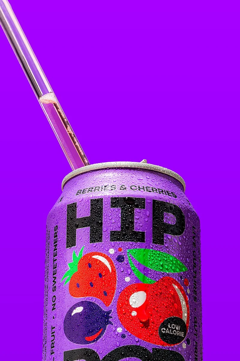 chilled can of hip pop drink macro photo showing condensation droplets with a hard light on a monotone background