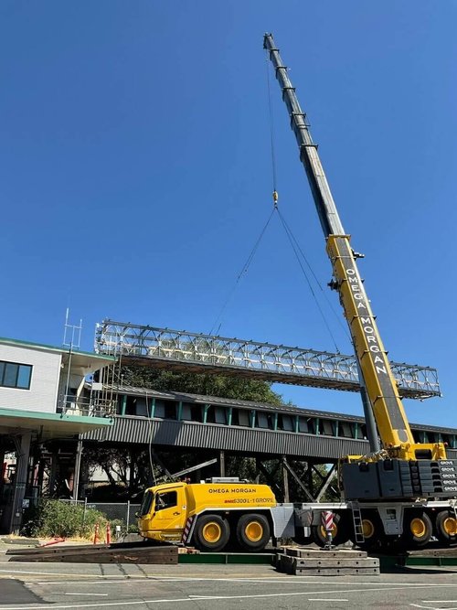 Crane lifting truss span at ferry terminal