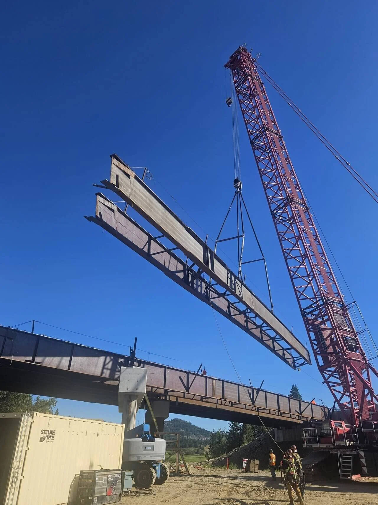 Tappen Overhead Bridges girder lift with LR 1600-2 crane against blue sky