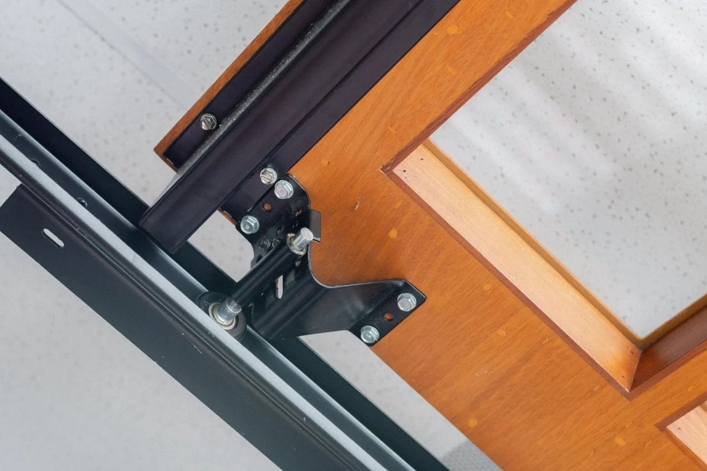 Garage door hinge, roller and track assembly during a maintenance inspection