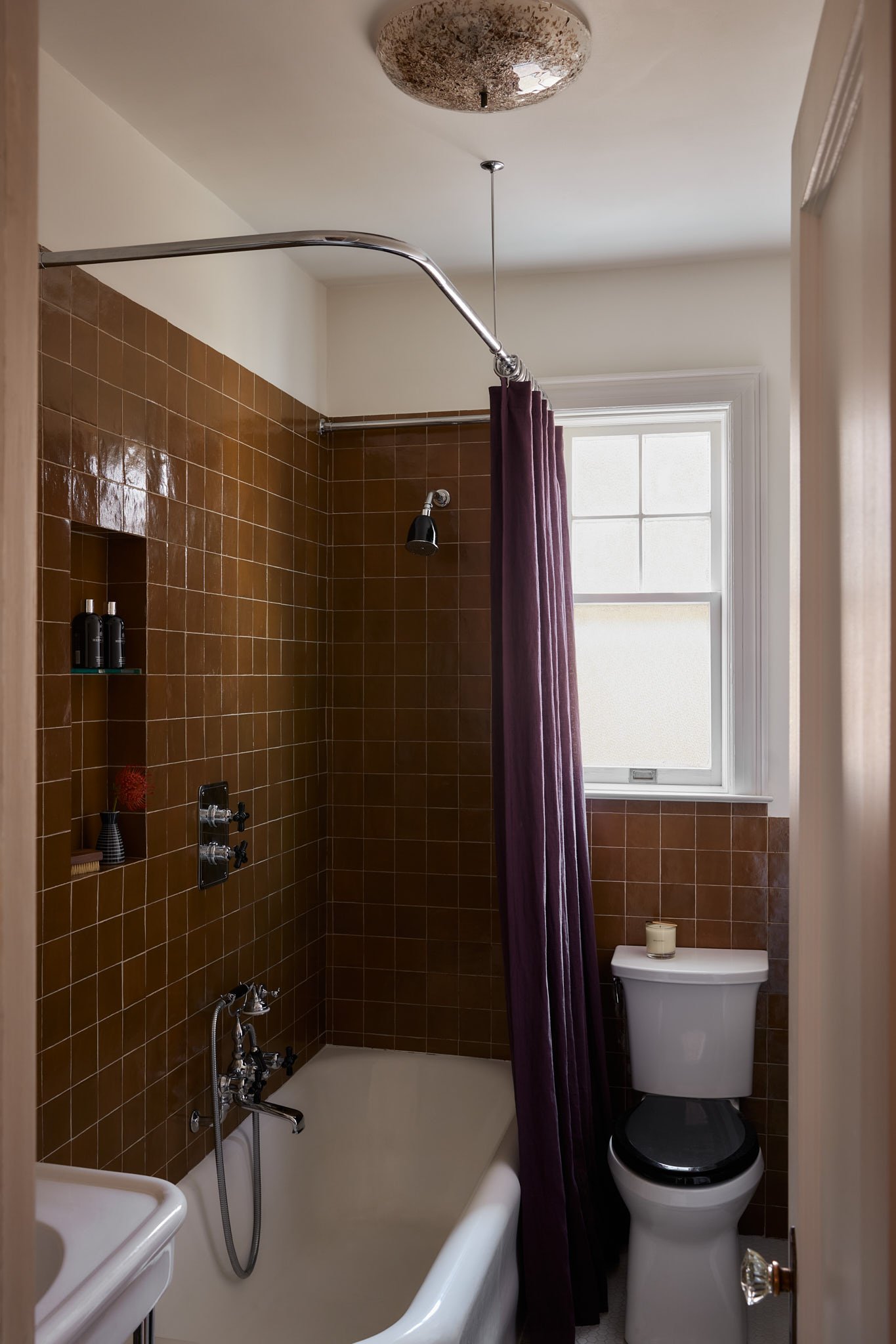 Bath design with vintage European lighting