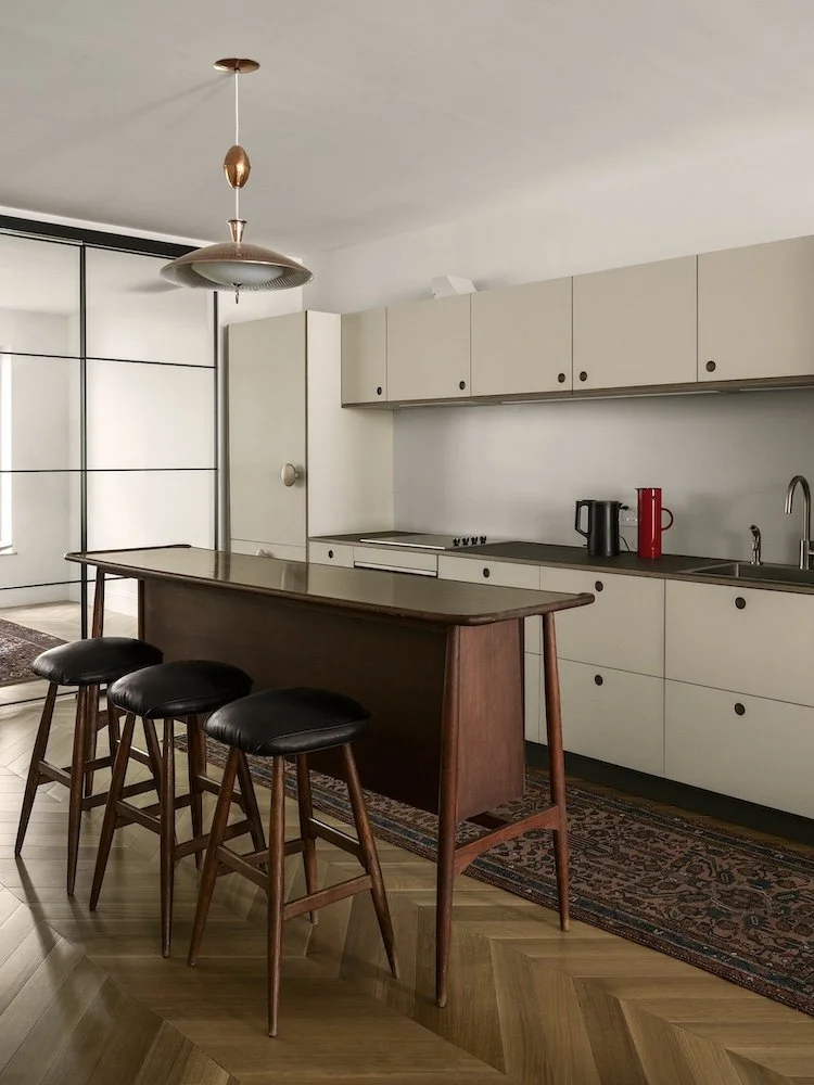 Park Slope renovated kitchen with vintage rug and Mid Century bar