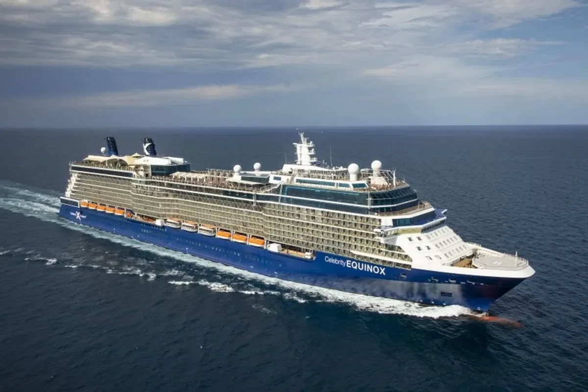 A large cruise ship named Celebrity Equinox sailing on the ocean with multiple decks and amenities visible on the exterior.