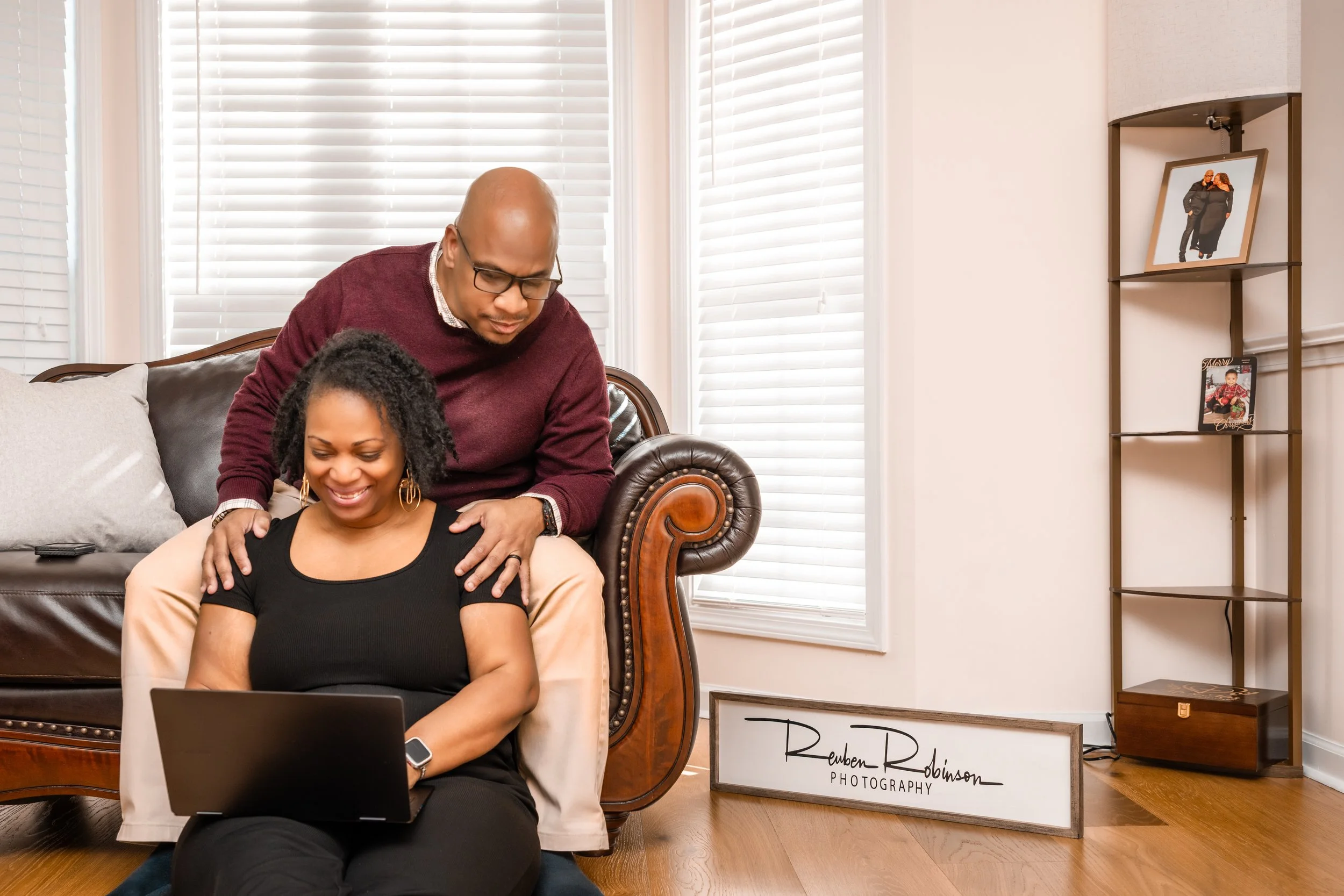 Reuben and Camille of Reuben Robinson Photography, an Atlanta wedding and corporate photography team, editing professional images together.